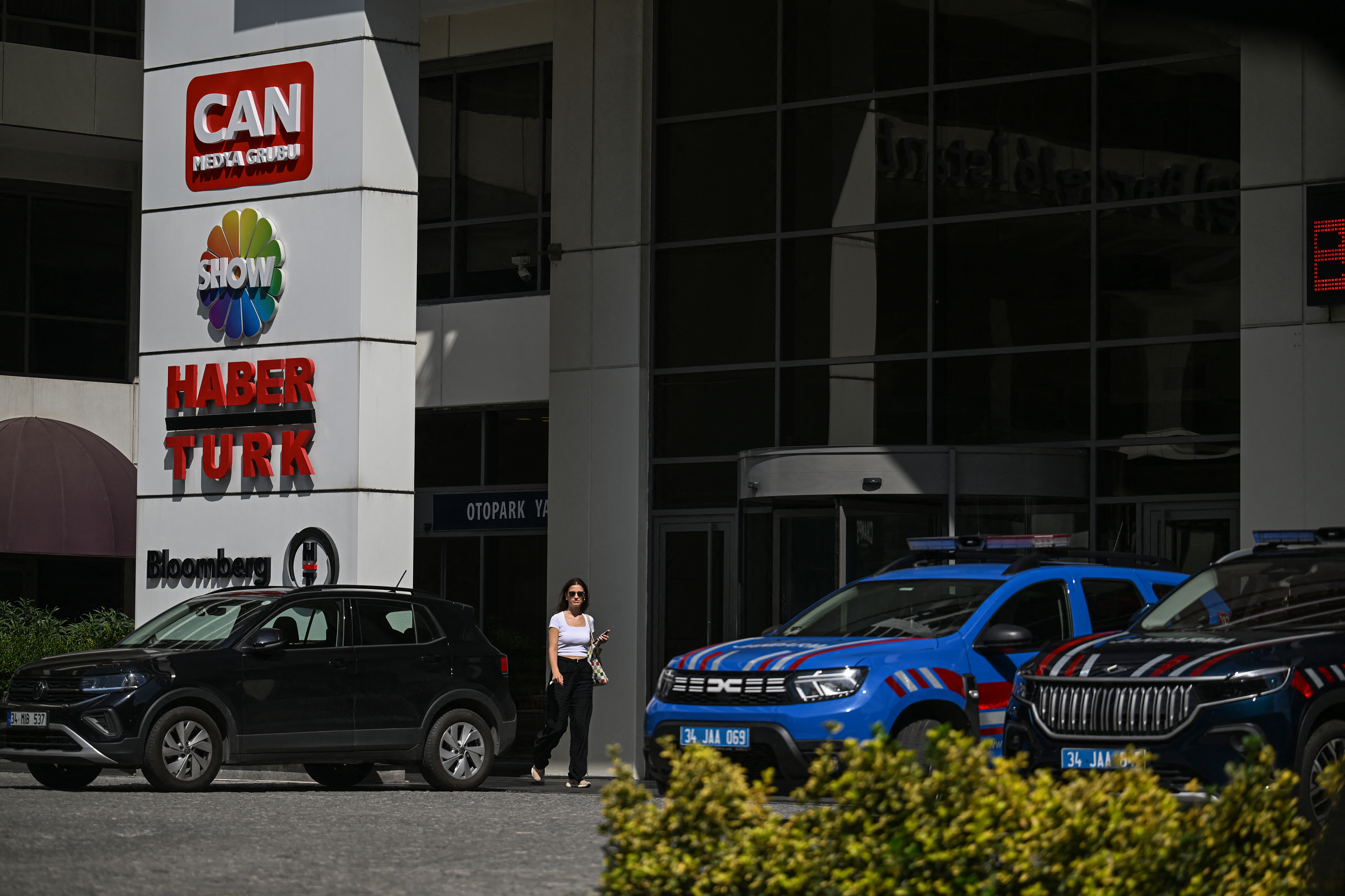 Turkish gendarmerie vehicles are seen at the entrance to Haberturk TV station's headquarters in Istanbul, on September 11, 2025. Turkish prosecutors on September 11, 2025 seized control of a 121-company conglomerate, which includes three major television stations, and ordered the arrest of 10 of its executives on fraud charges, media reports said. The arrest order targeted management at Can Holding, which is known for its energy and education assets and which last year acquired prominent TV channels including Haberturk, Show TV and Bloomberg HT, an affiliate of Bloomberg News. (Photo by Ozan KOSE / AFP)