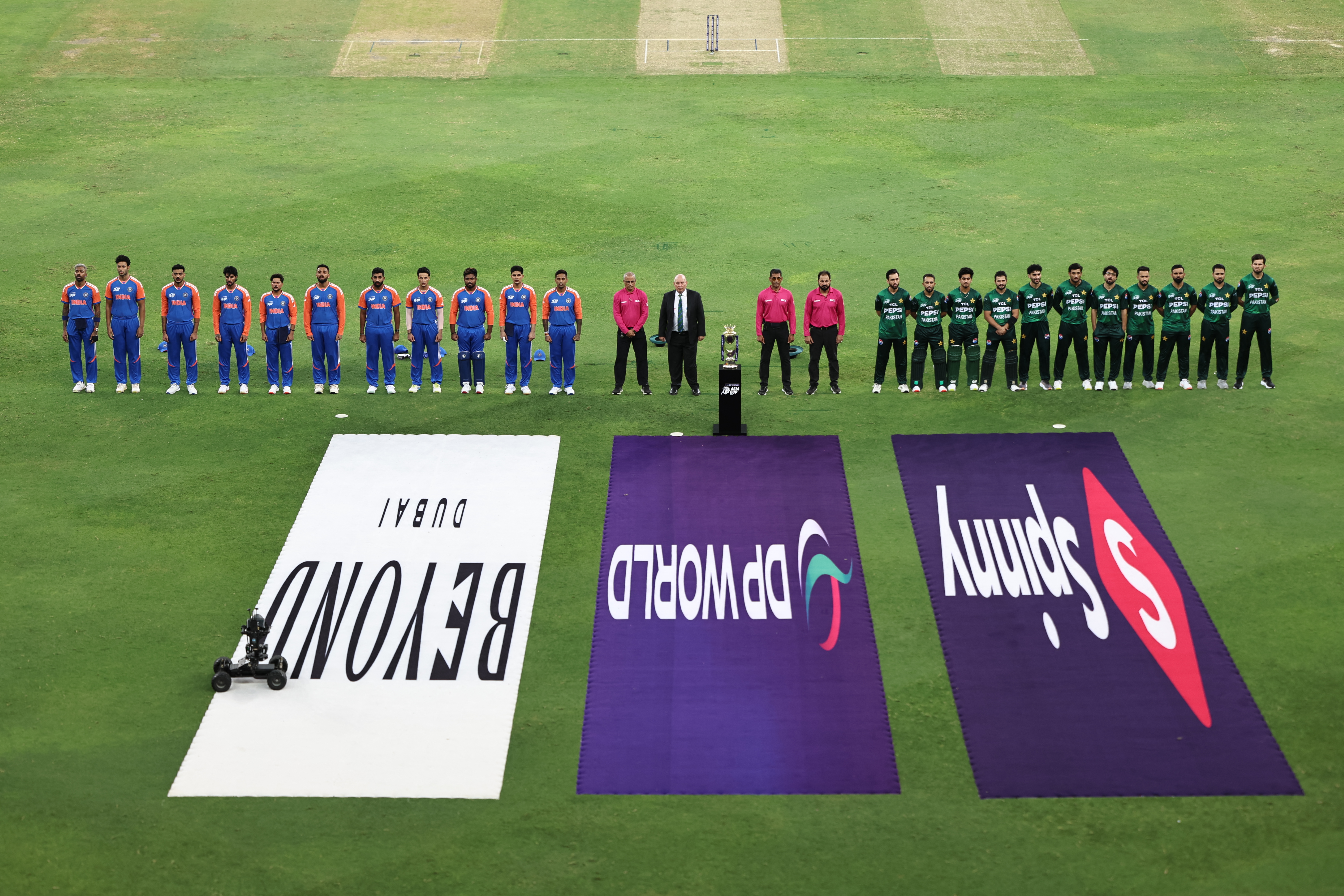India's (L) and Pakistan's players stand for their national anthems before the start of the Asia Cup 2025 Twenty20 international cricket match between India and Pakistan at the Dubai International Stadium in Dubai on September 14, 2025. (Photo by Fadel SENNA / AFP)