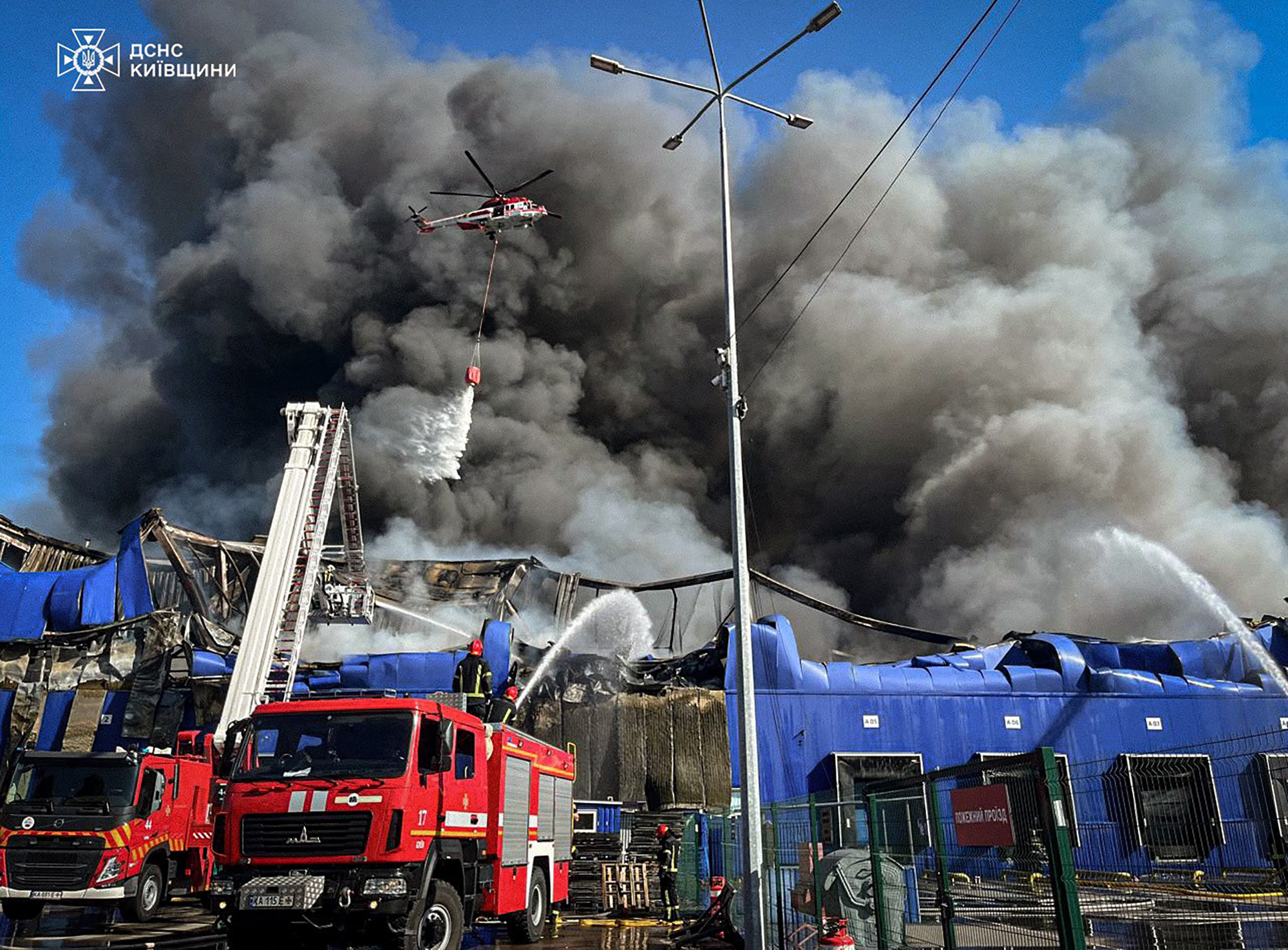 In this handout photograph taken and released by the Ukrainian Emergency Service on September 16, 2025, Ukrainian rescuers work to extinguish a fire at the site of a drone attack at an undisclosed location in the Fastiv district of the Kyiv region, amid the Russian invasion of Ukraine. (Photo by Handout / UKRAINIAN EMERGENCY SERVICE / AFP) / RESTRICTED TO EDITORIAL USE - MANDATORY CREDIT "AFP PHOTO / UKRAINIAN EMERGENCY SERVICE" - HANDOUT - NO MARKETING NO ADVERTISING CAMPAIGNS - DISTRIBUTED AS A SERVICE TO CLIENTS - AFP CANNOT INDEPENDENTLY VERIFY THE AUTHENTICITY OR LOCATION, DATE, AND CONTENT OF THESE IMAGES.