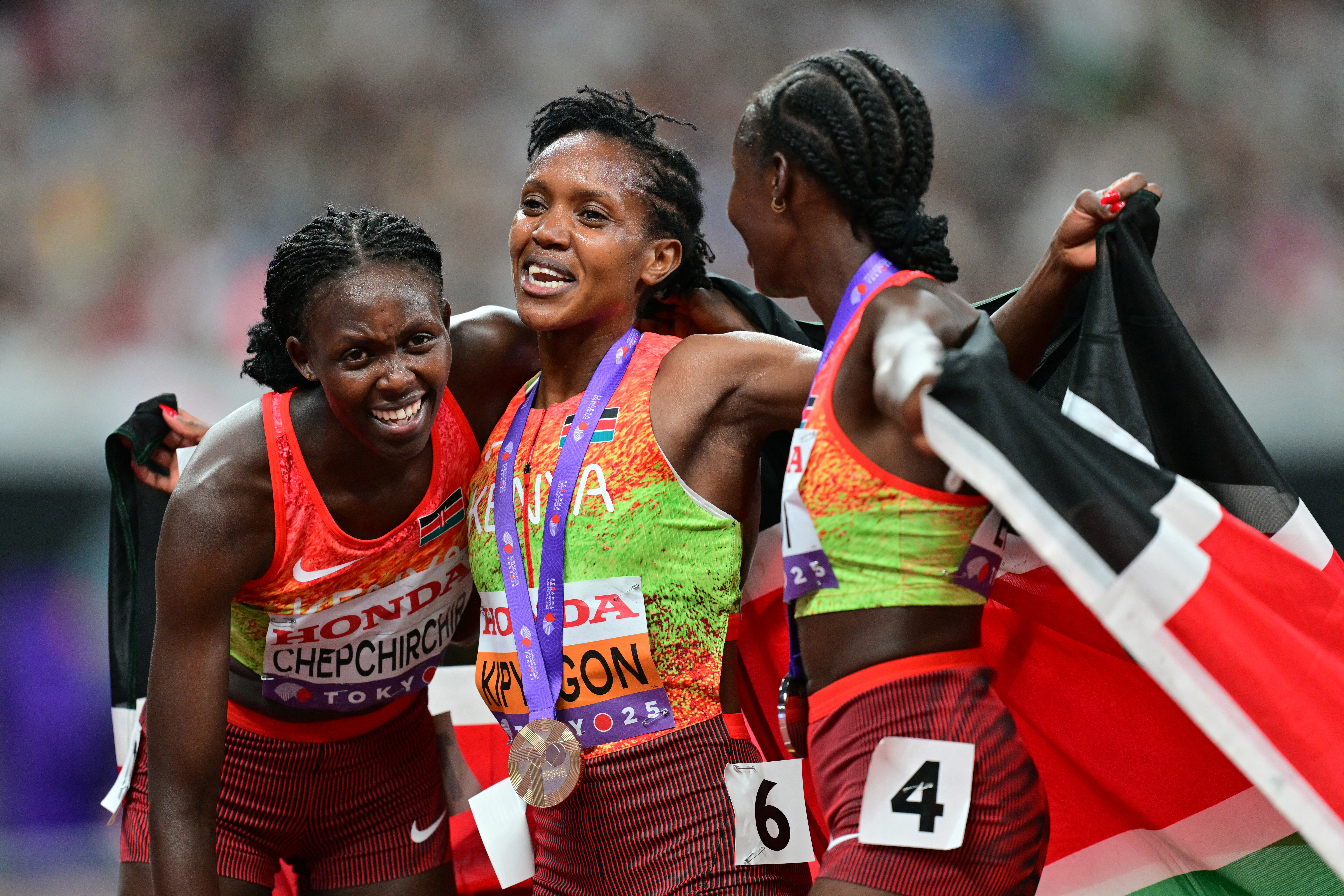 Kenya's Nelly Chepchirchir, Kenya's Faith Kipyegon and Kenya's Dorcus Ewoi celebrate after the women's 1500m final during the World Athletics Championships in Tokyo on September 16, 2025. (Photo by Andrej ISAKOVIC / AFP)