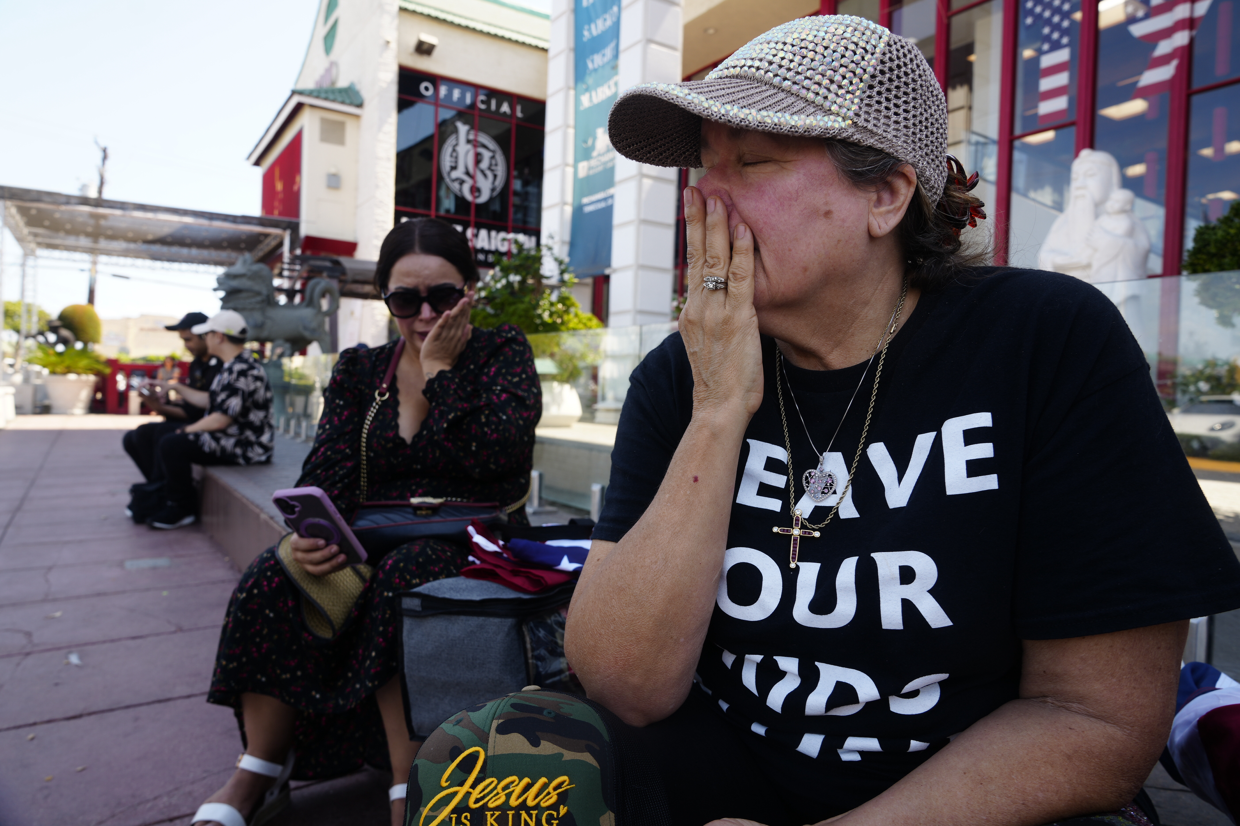 Cecilia Garcia and Dawn Thomas react as they learn the news on social media of Charlie Kirk, a conservative activist being shot at a college event in Utah, in Westminster, Calif., on Wednesday, Sept. 10, 2025. (AP Photo/Damian Dovarganes)