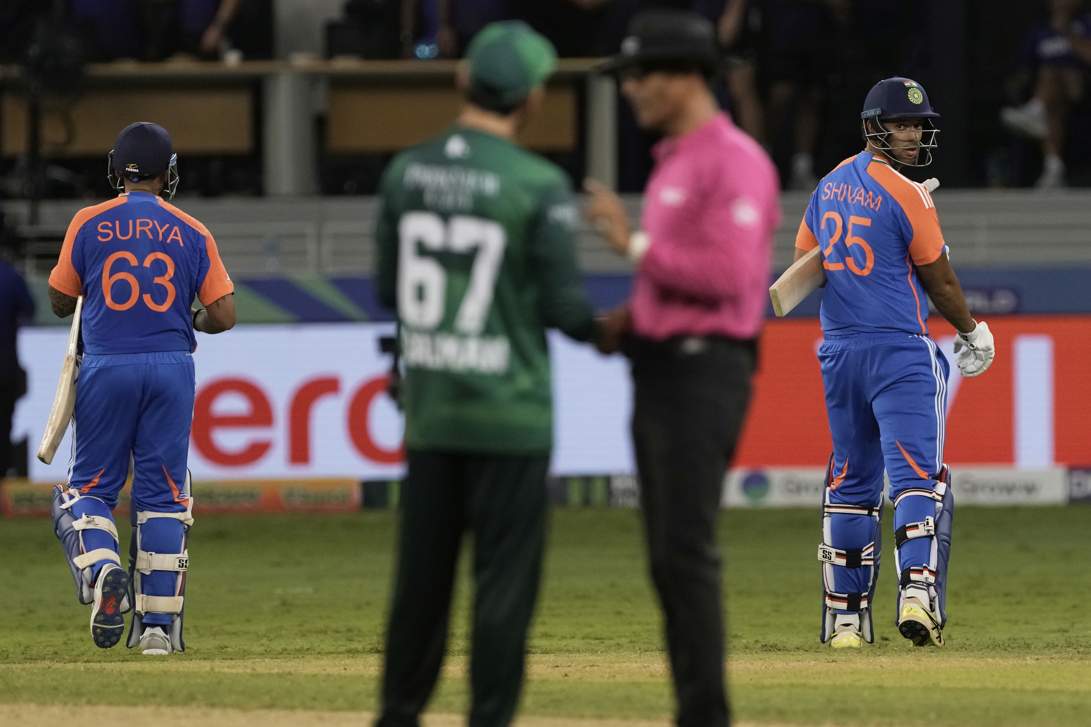 India's captain Suryakumar Yadav, left, and batting partner Shivam Dube, right, leave the field after their win in the Asia Cup cricket match against Pakistan at Dubai International Cricket Stadium in Dubai, United Arab Emirates, Sunday, Sept. 14, 2025. (AP Photo/Fatima Shbair)