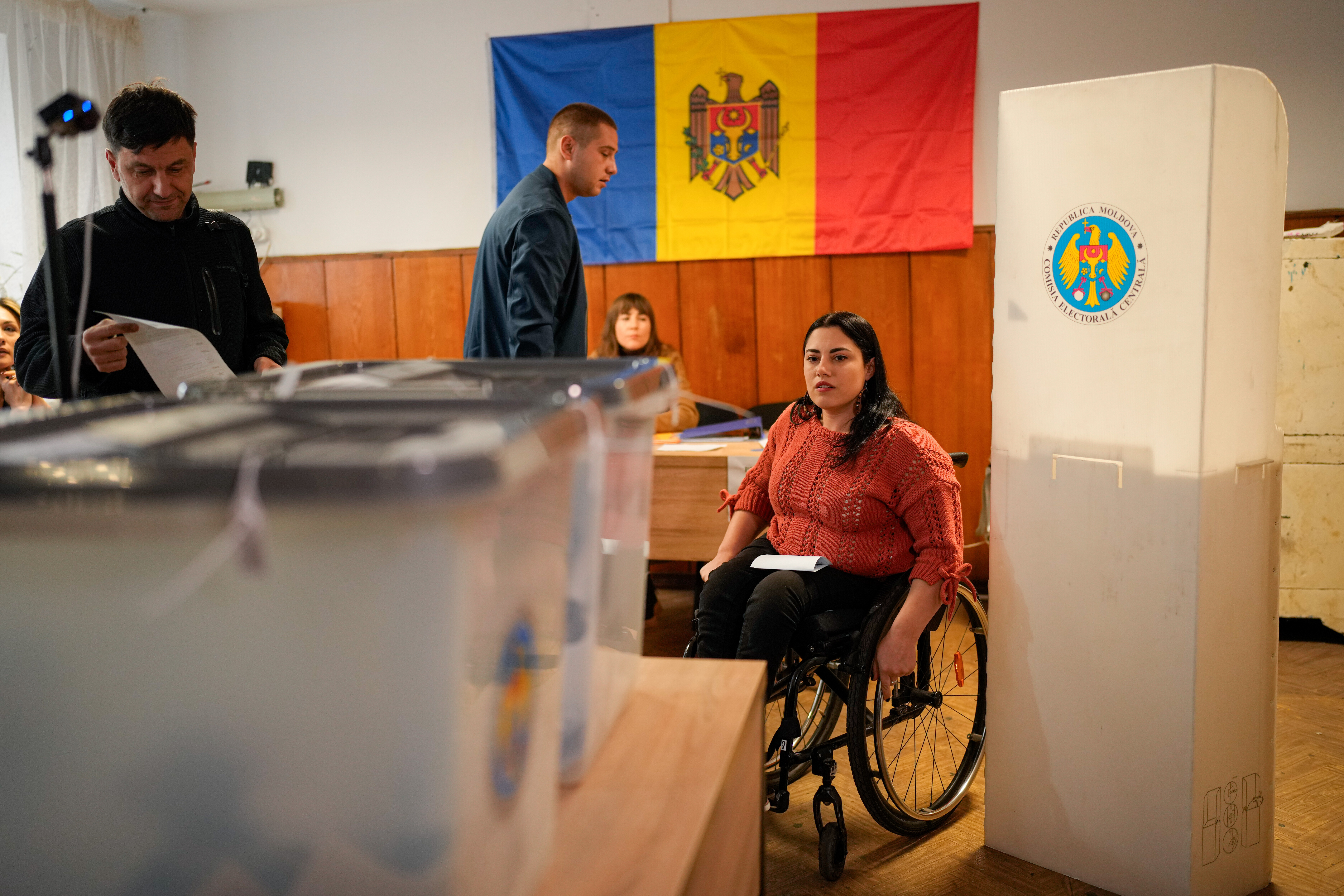 A wheelchair user prepares to cast her vote.