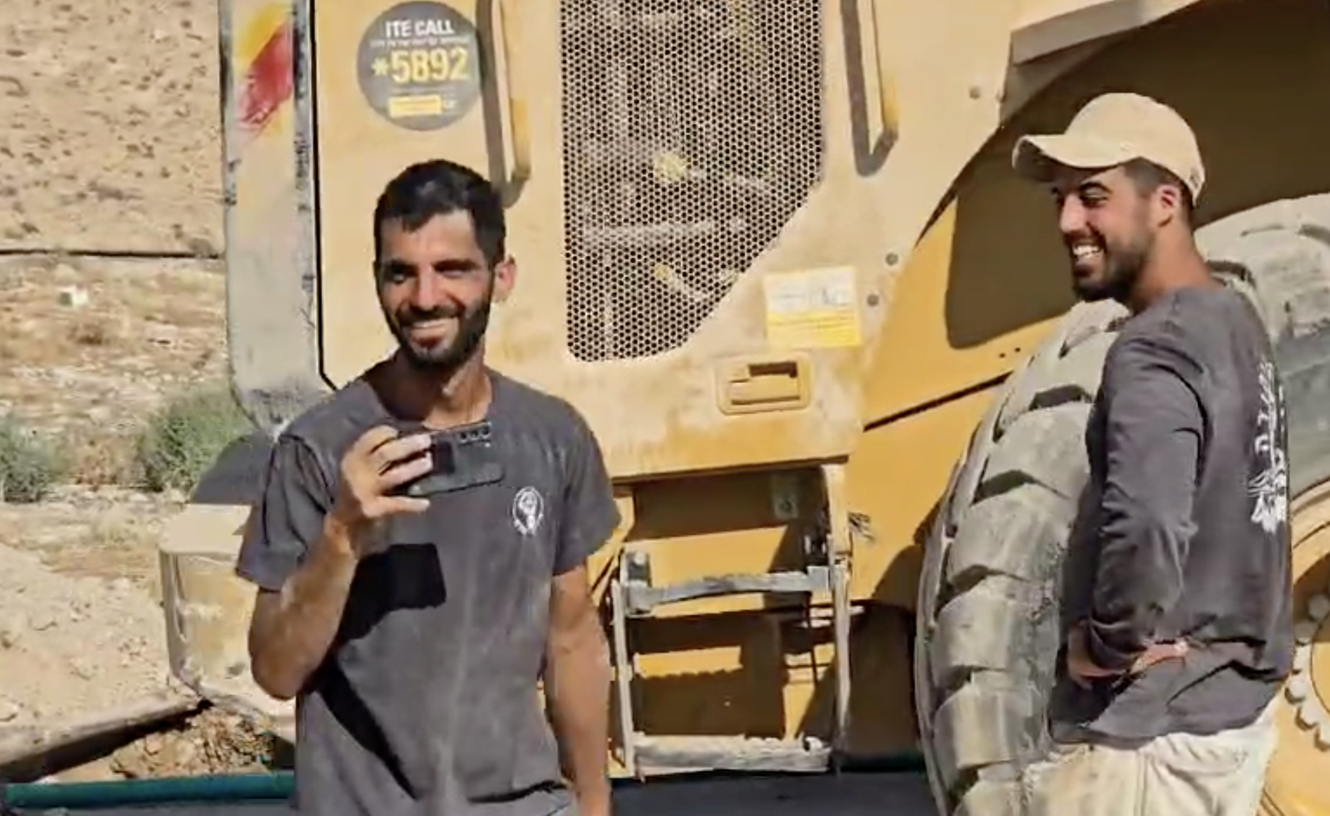 Israeli settler Yinon Levi, left, smiling and goading activists filming his sabotage, after destroying Um al-Khair's power and water lines in the occupied West Bank