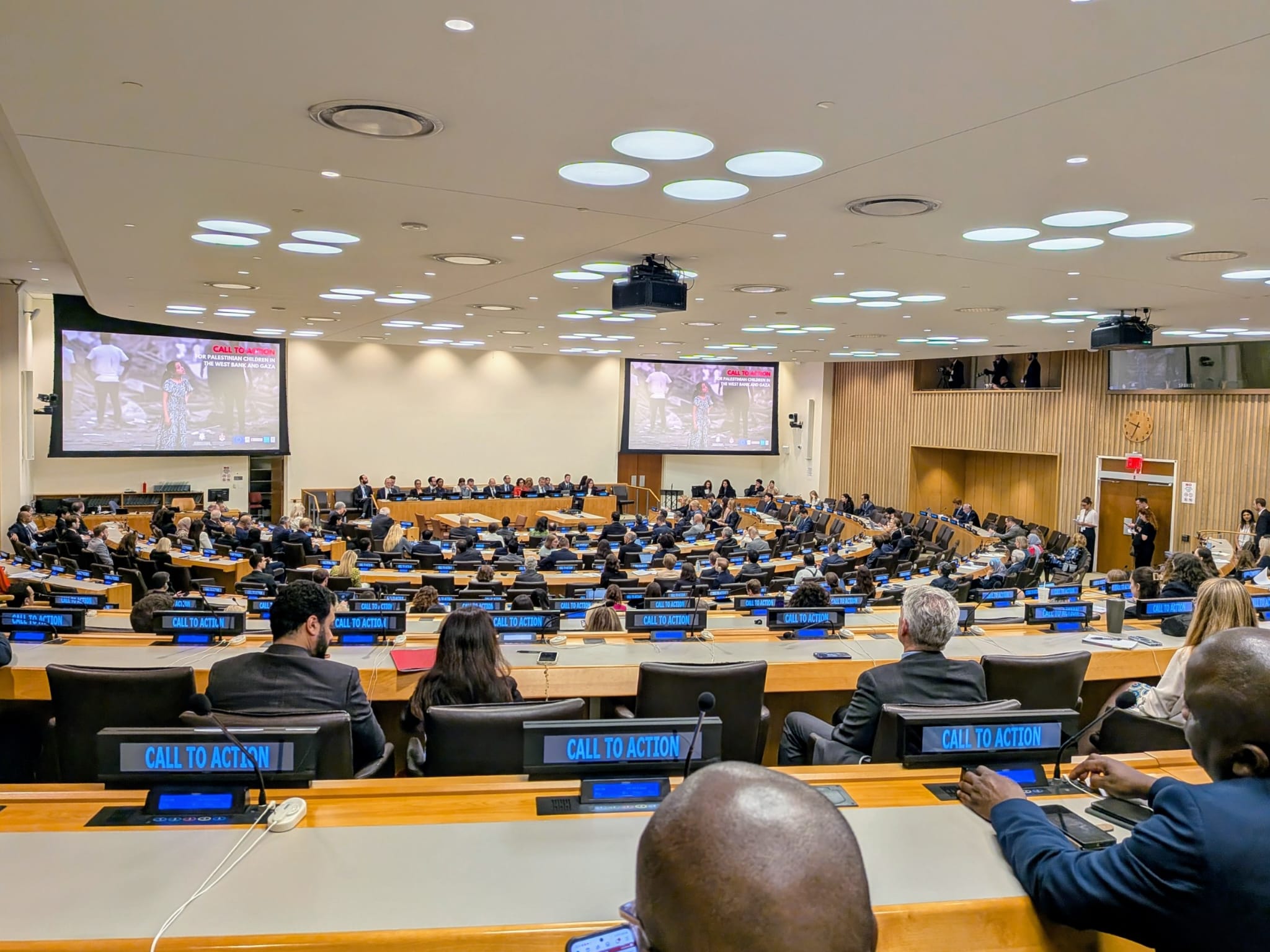 A sideline event at the UN General Assembly, with screens showing a "call to action."