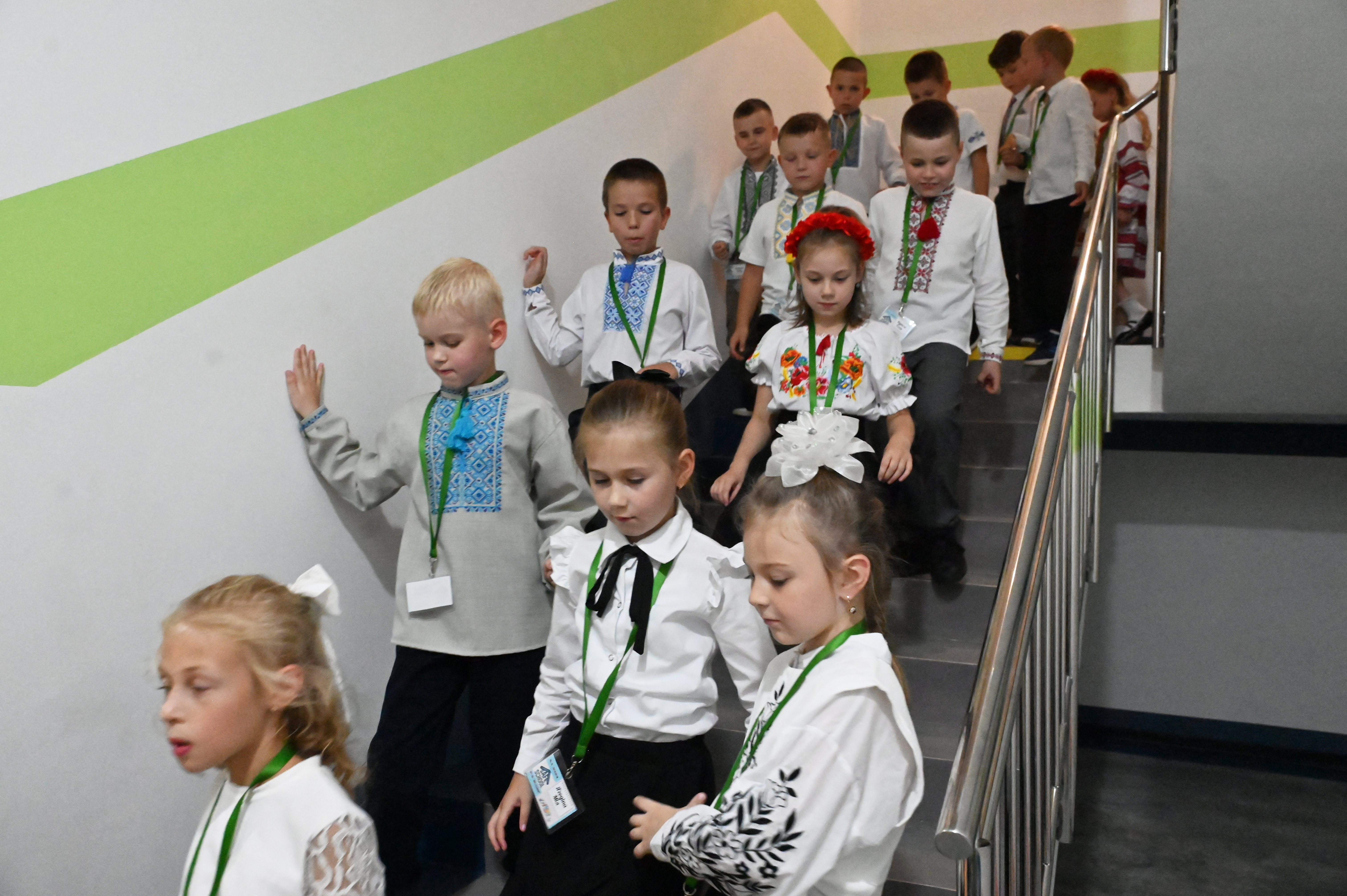 Pupils walk down a stairwell on the first day of the new school year at an underground school, wich was built to protect children from Russian missile attacks, in Kharkiv on September 1, 2025, amid the Russian invasion of Ukraine.