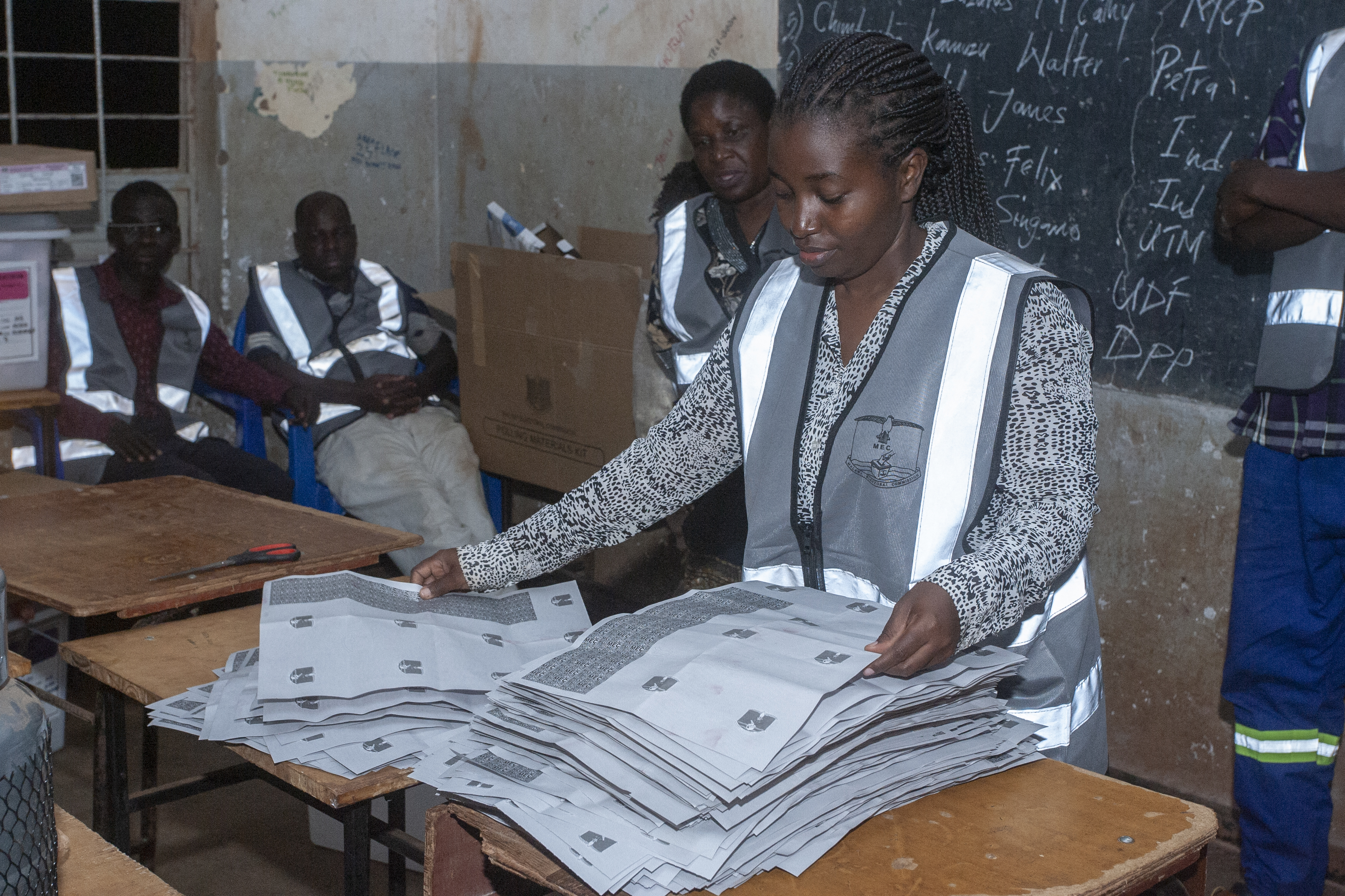Election officials count votes at the end of polling for the presidential and parliamentary elections, in Lilongwe on September 16, 2025. (Photo by Amos GUMULIRA / AFP)