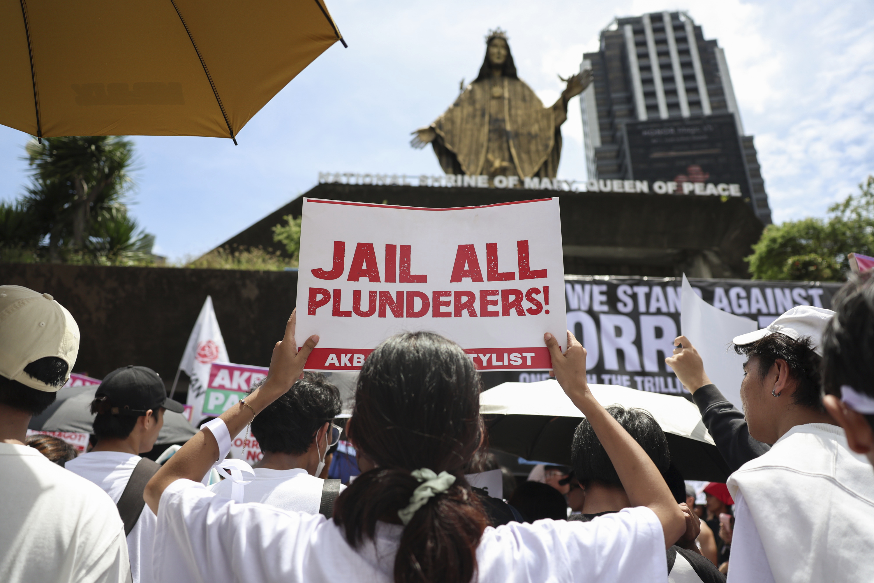 Protesters hold signs during a rally against the government corruption at the historic EDSA Shrine in suburban Mandaluyong, east of Manila, Philippines, Sunday. Sept. 21, 2025. (AP Photo/Basilio Sepe)