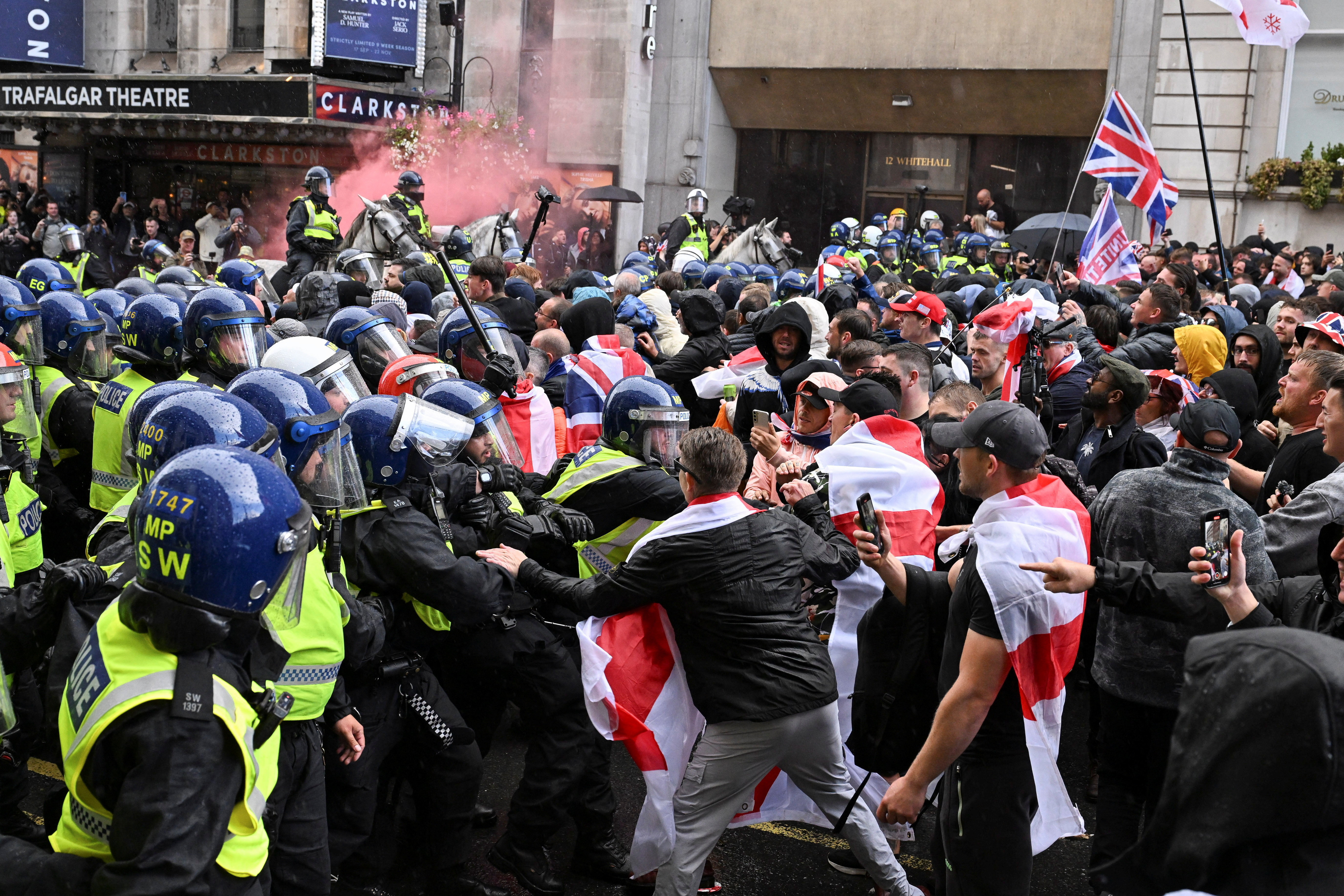 Police officers clash with supporters of British anti-immigration activist Stephen Yaxley-Lennon, also known as Tommy Robinson, during a rally, in London, Britain, September 13, 2025. REUTERS/Chris J. Ratcliffe