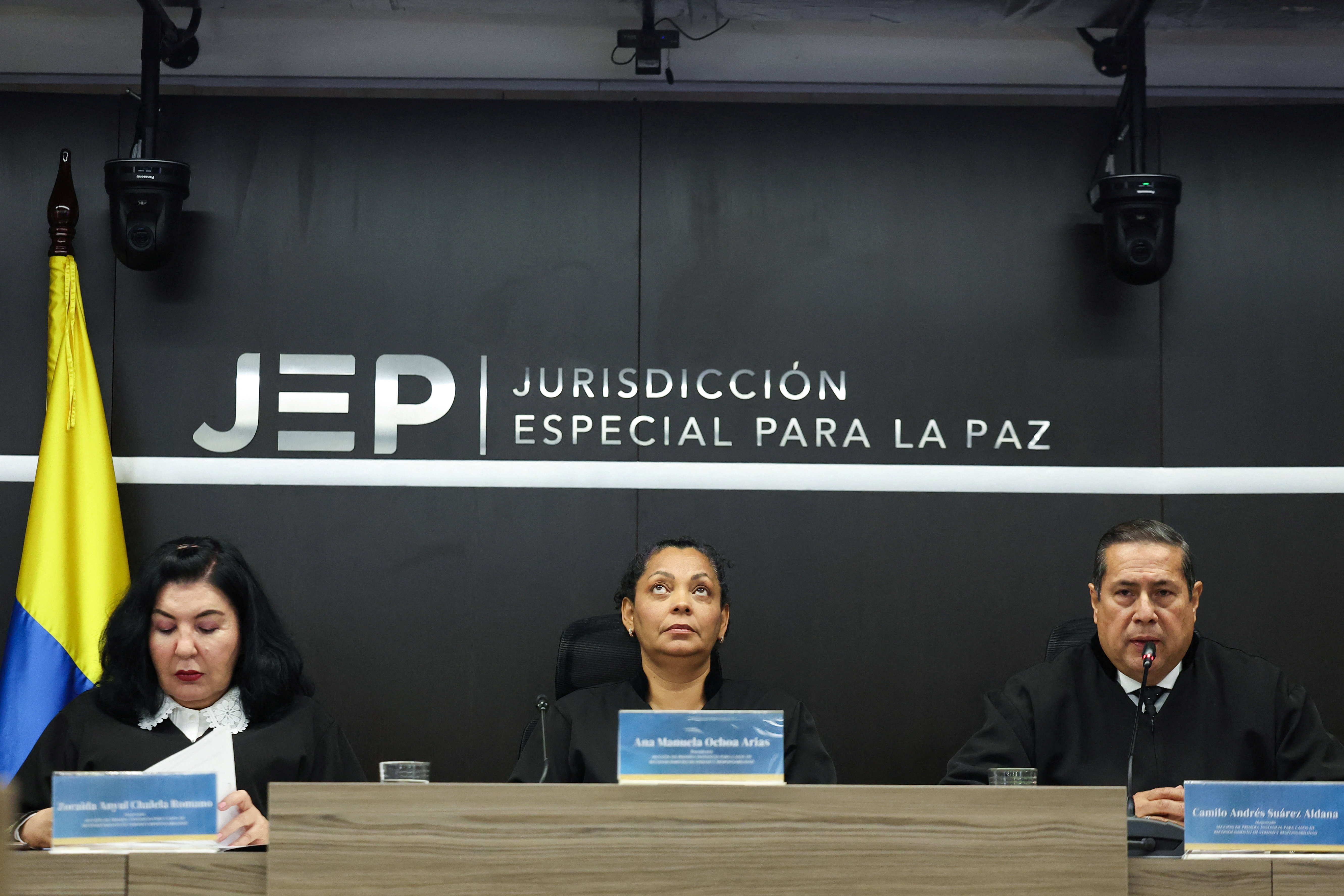 Magistrates of the Special Jurisdiction for Peace (JEP), Ana Manuela Ochoa, Camilo Andres Suarez and Juan Ramon Martinez, attends the reading of sentences against former FARC commanders for kidnappings, in Bogota, Colombia September 16, 2025. REUTERS/Luisa Gonzalez