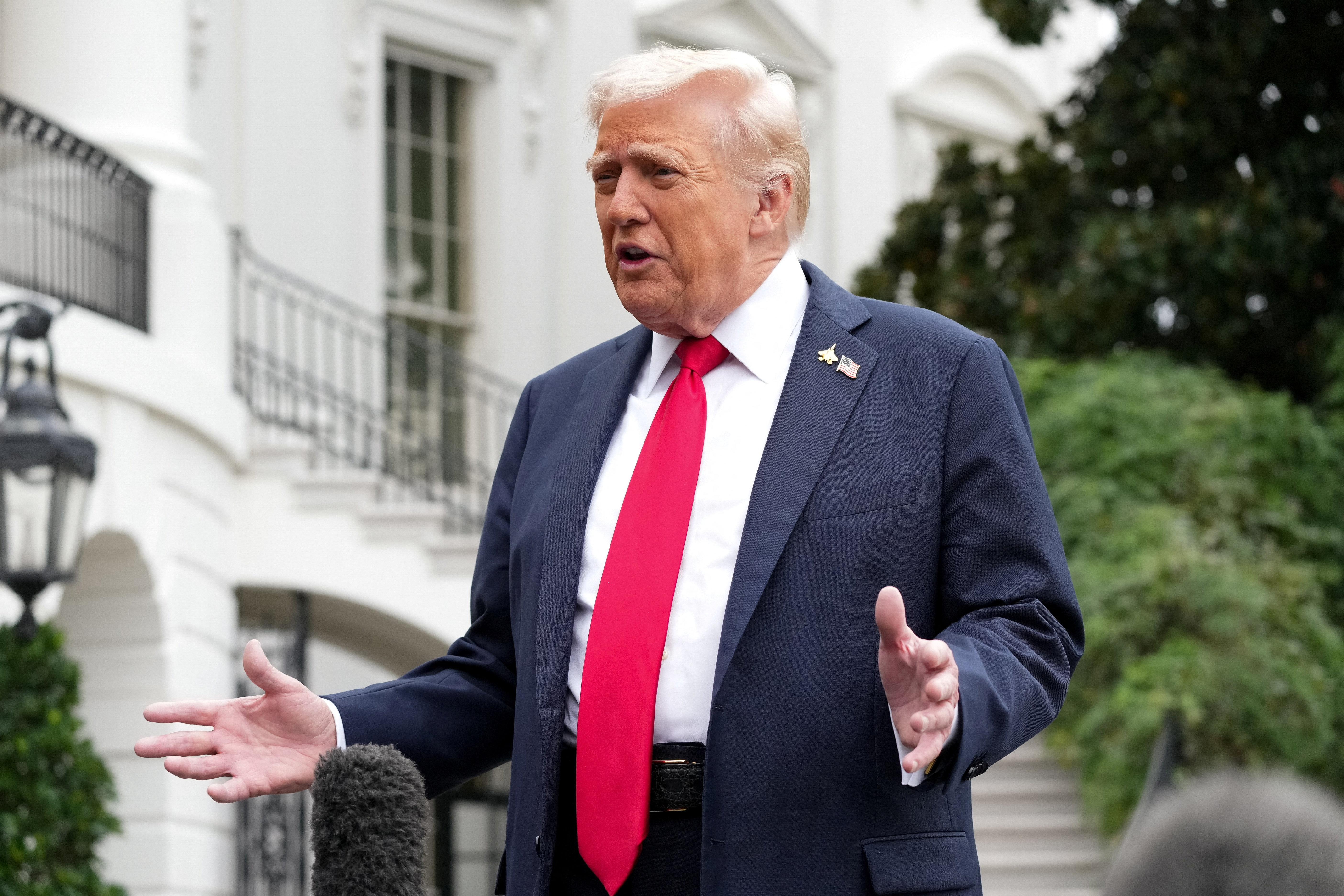 U.S. President Donald Trump speaks to the press before boarding Marine One to depart for Quantico, Virginia, from the South Lawn at the White House in Washington, D.C., U.S., September 30, 2025. REUTERS/Ken Cedeno