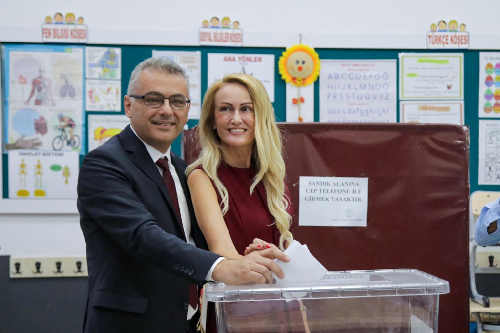 Republican Turkish Party leader Tufan Erhurman and his wife Nilden Erhurman cast their ballots at a polling station during the Turkish Cypriot leadership election on October 19, 2025. [Birol Bebek/AFP]