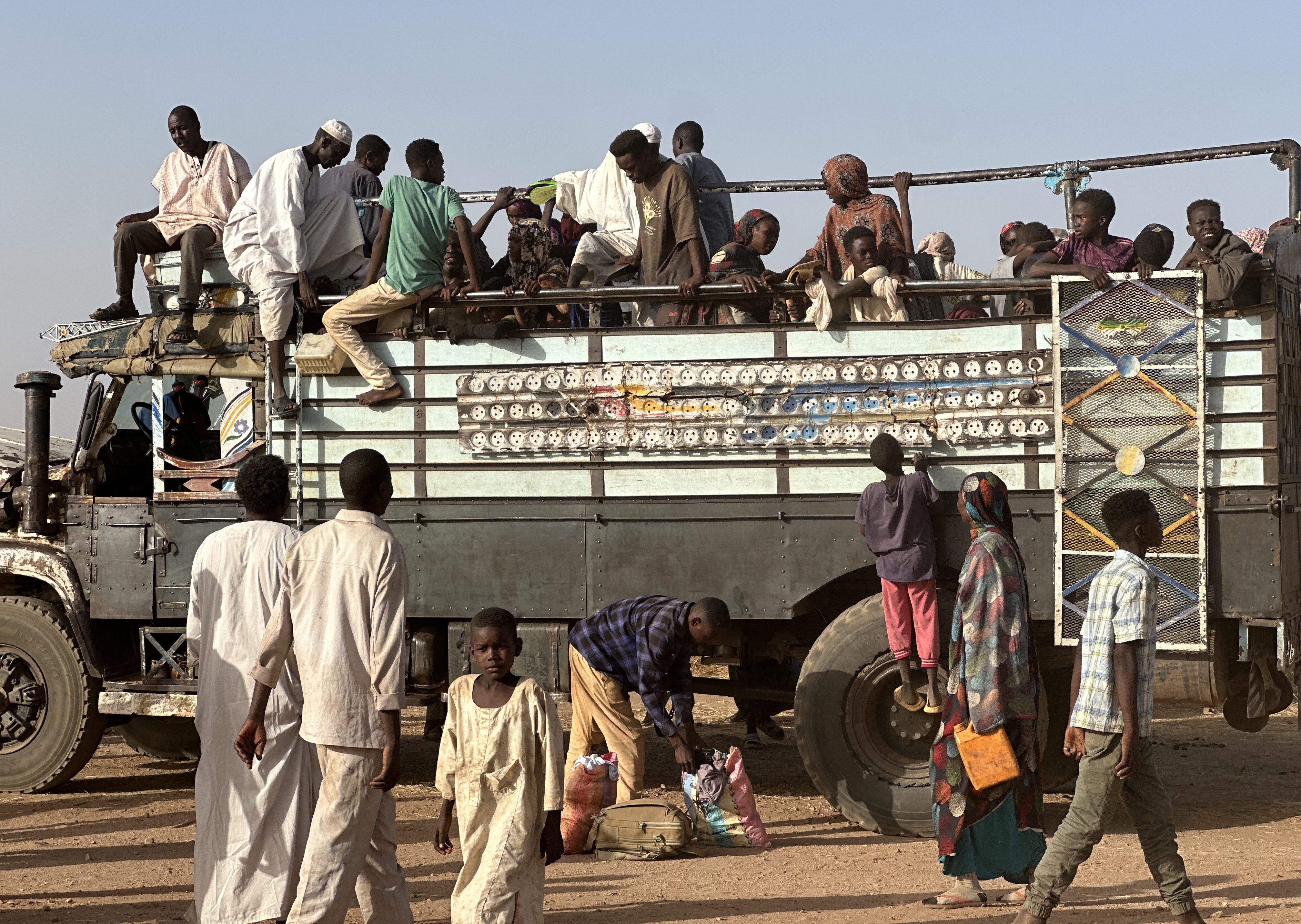 Sudanese people crowd a bus.