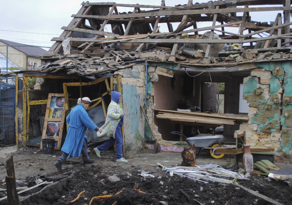 epa12446997 Local people clean debris near their damaged home in Odesa, Ukraine, 11 October 2025, amid the ongoing Russian invasion. At least one person was injured after the overnight mass Russian drones attack on energy and civil infrastructure objects in the Odesa region, according to the State Emergency Service. EPA/IGOR TKACHENKO