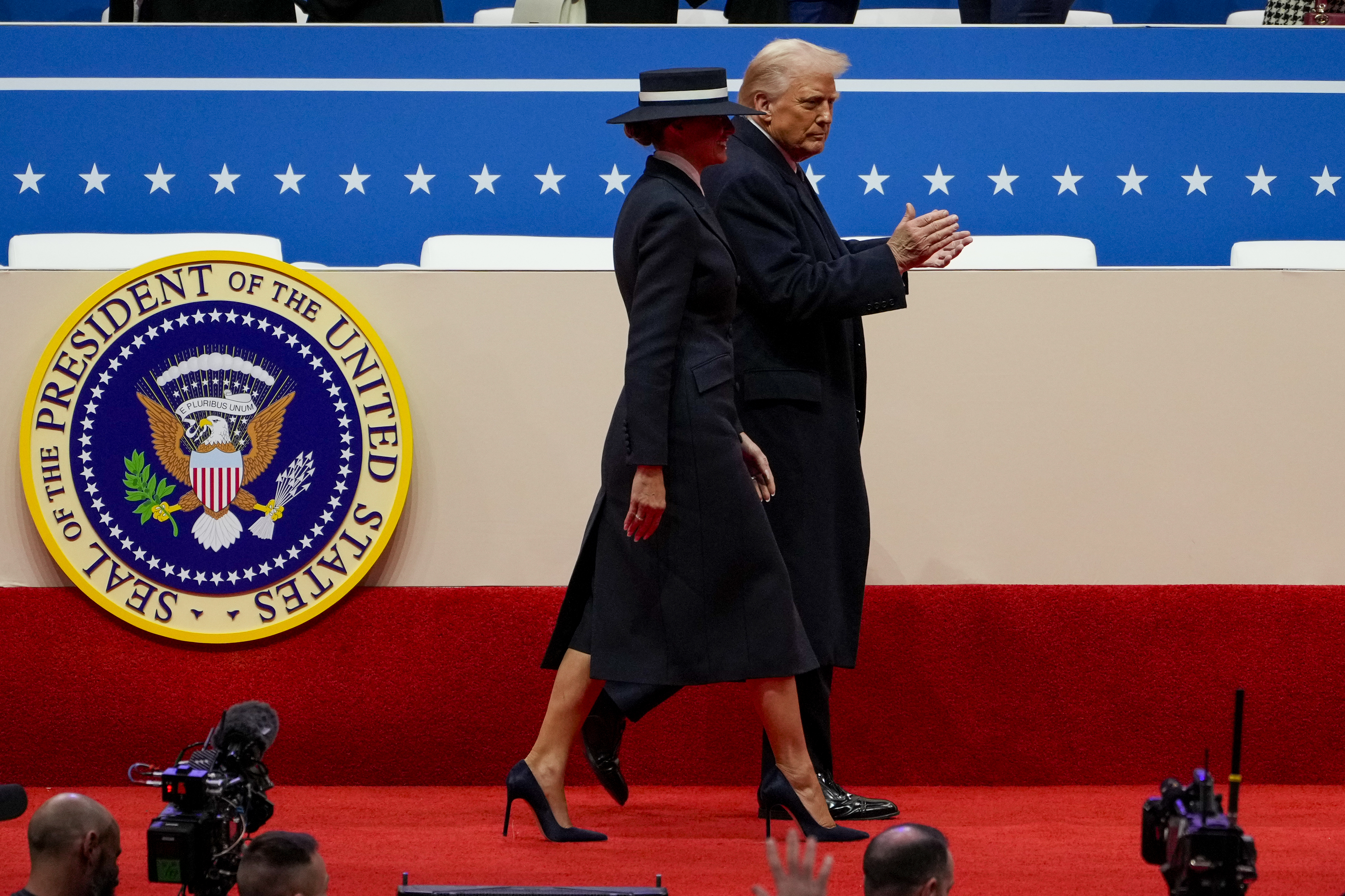 Melania and Donald Trump walk during Capitol One Arena event