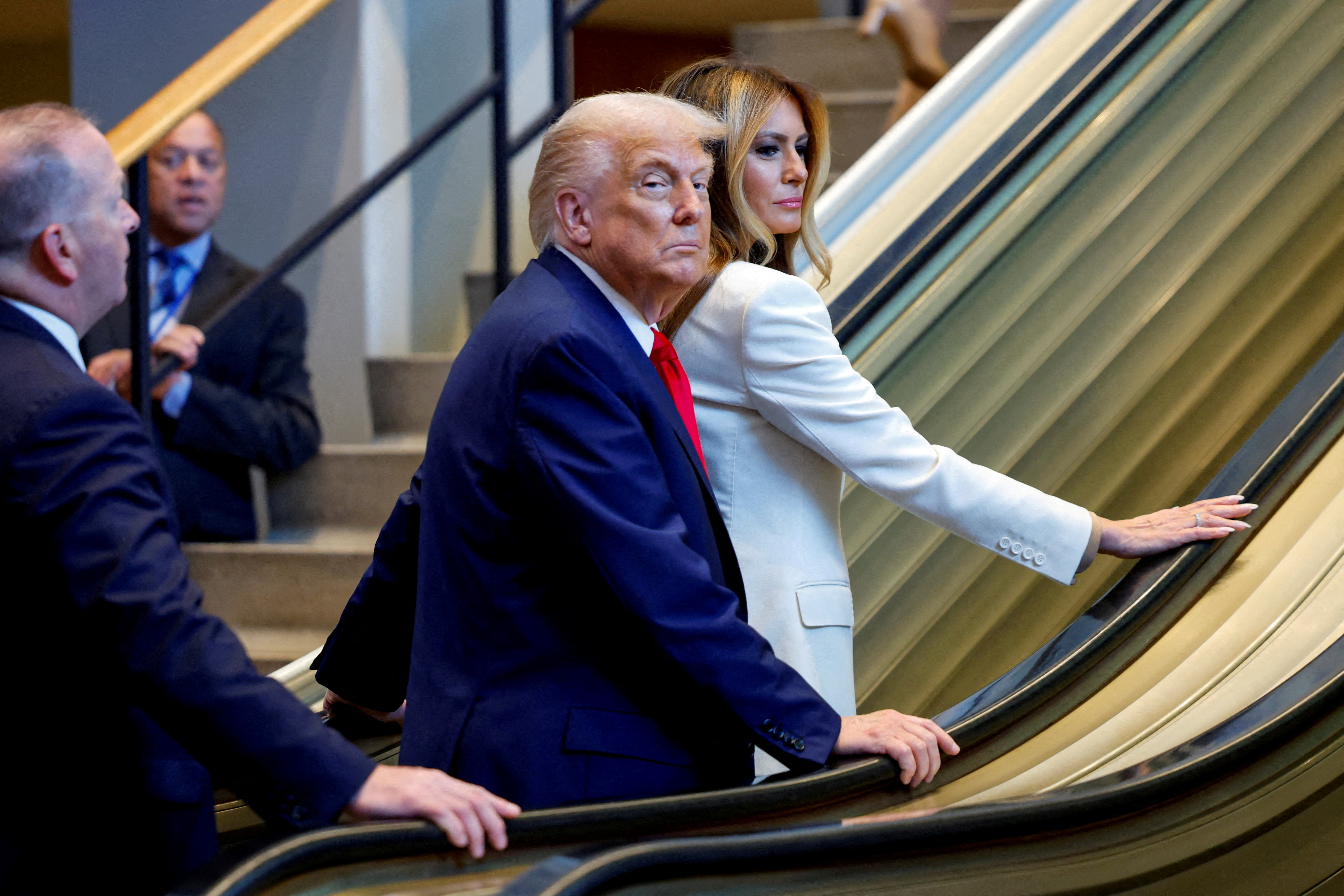 Donald Trump and Melania Trump pause on a stalled elevator.