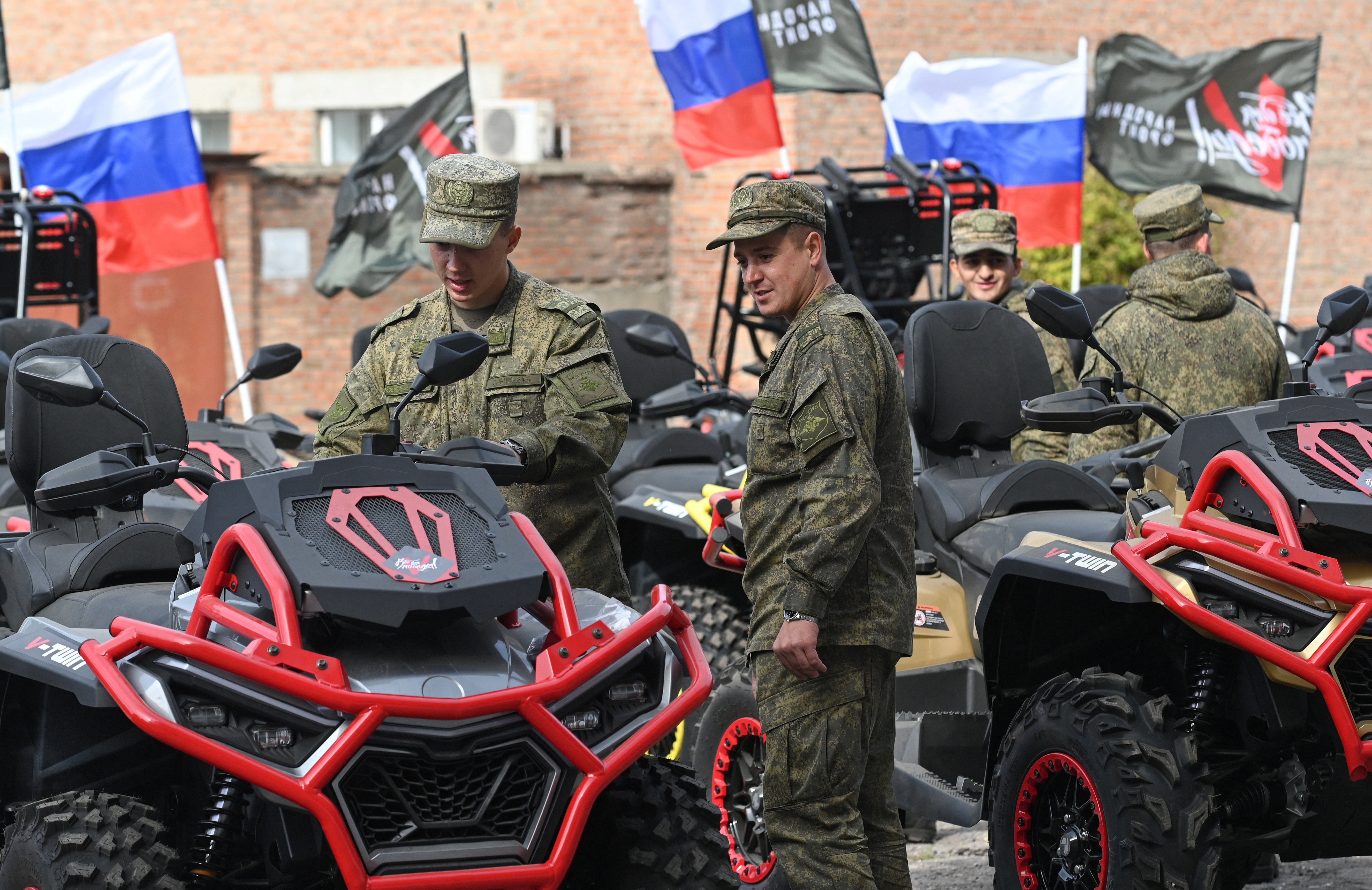 Russian service members attend a ceremony organized by the People's Front political movement to hand over new motocross bikes, quad bikes and unmanned aerial vehicles to Russia's army for use in the ongoing military conflict against Ukraine, in Rostov-on-Don, Russia, October 3, 2025. REUTERS/Sergey Pivovarov