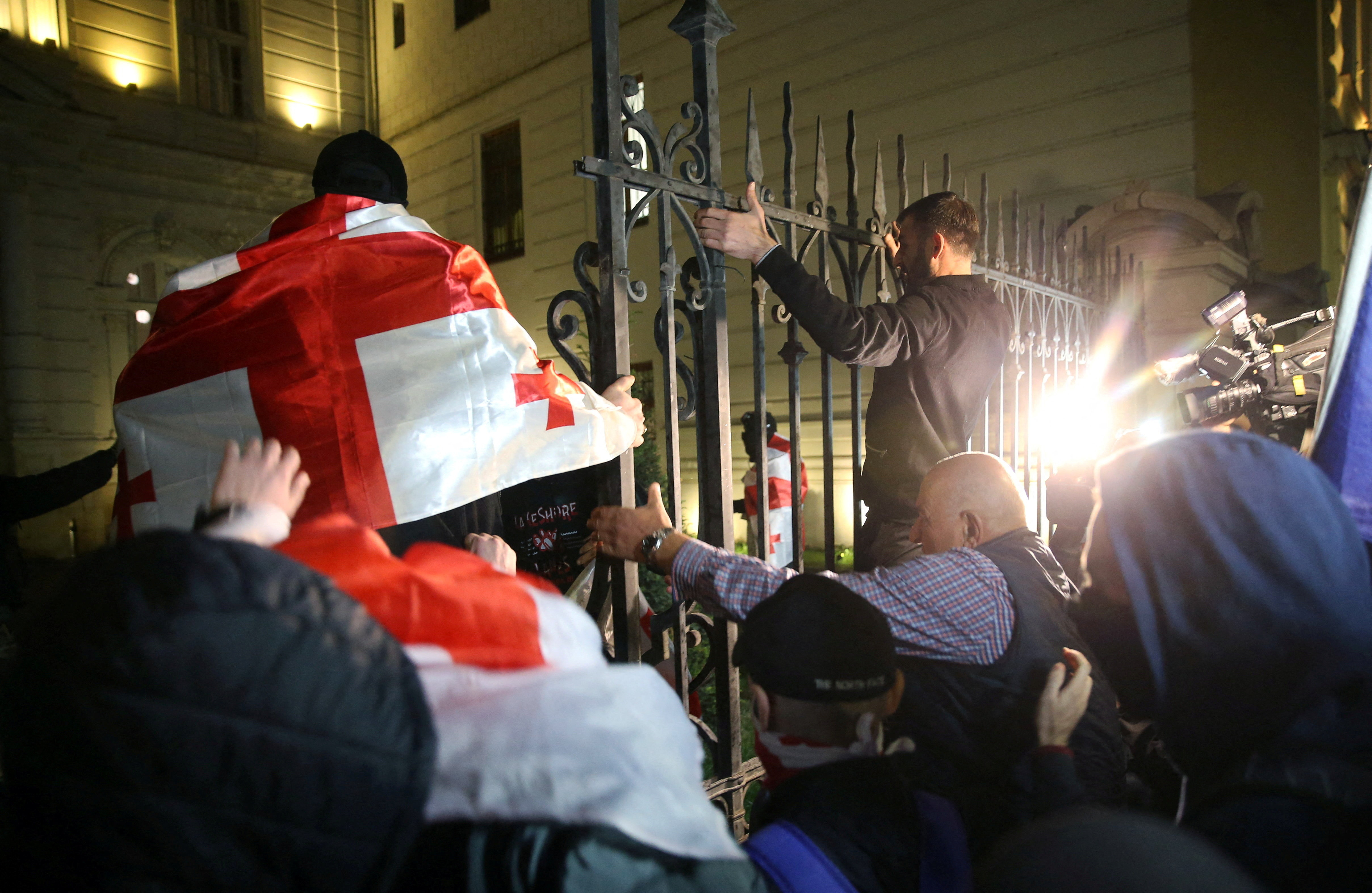 Protesters attempt to break into the presidential palace grounds during an opposition rally