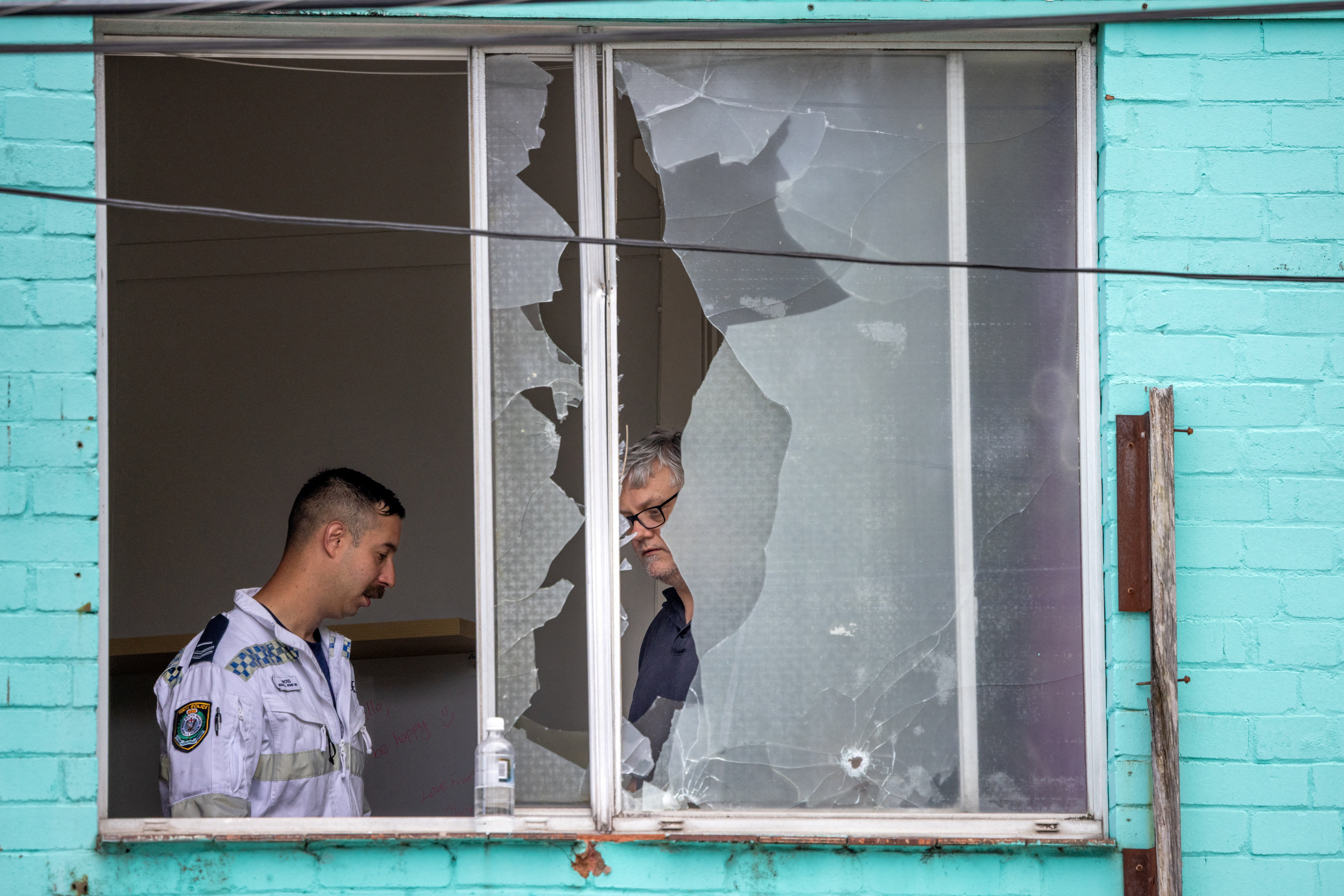 A police officer works at the site after a man fired at passersby from an apartment in Sydney, Australia