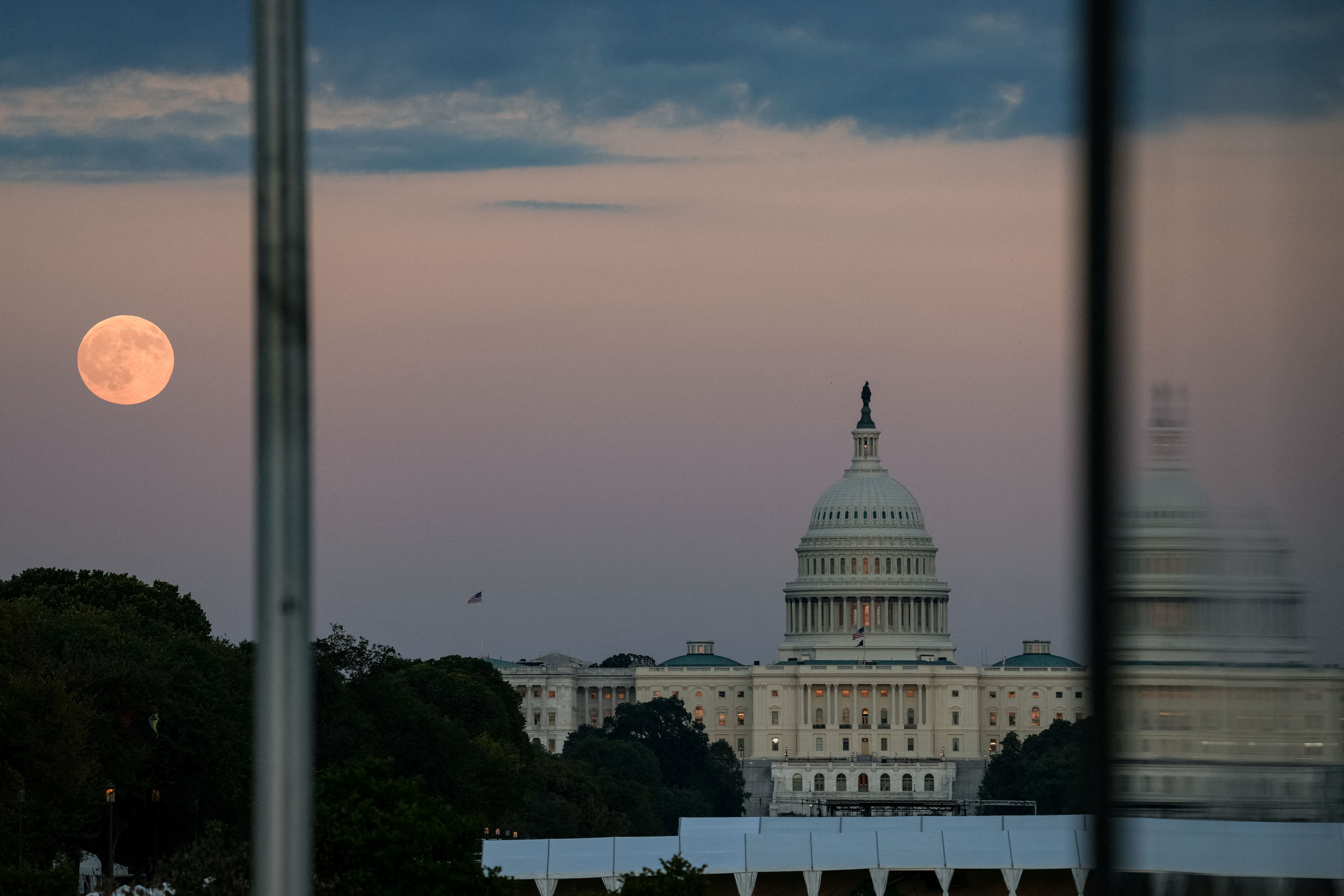 The first supermoon of the year, known as the Harvest Moon, rises above the National Mall in Washington, DC.