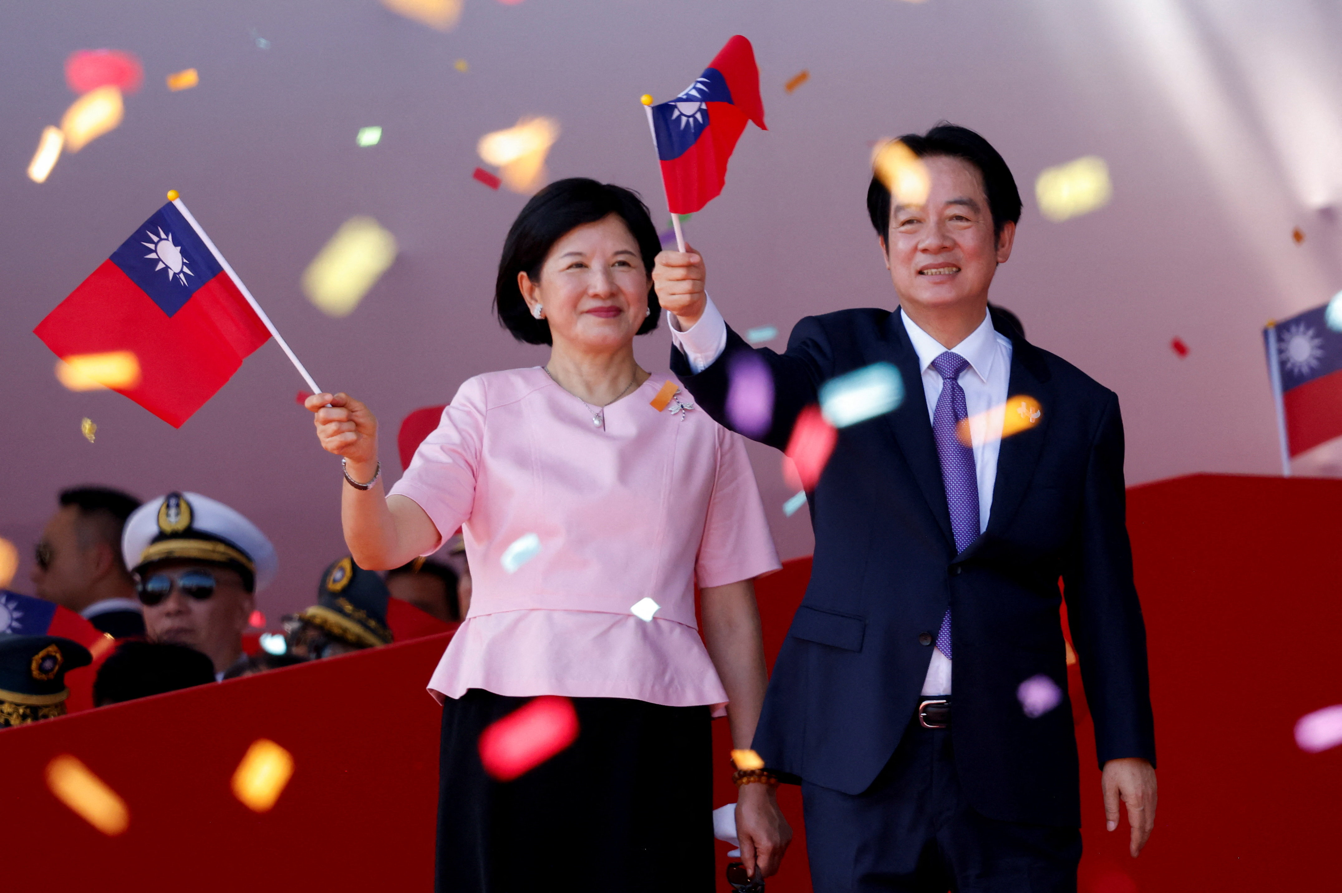 Taiwan President Lai Ching-te waves a Taiwan flag with his wife Taiwan's First Lady Wu Mei-ju on the day he delivers a speech during National Day celebrations in Taipei, Taiwan, October 10, 2025