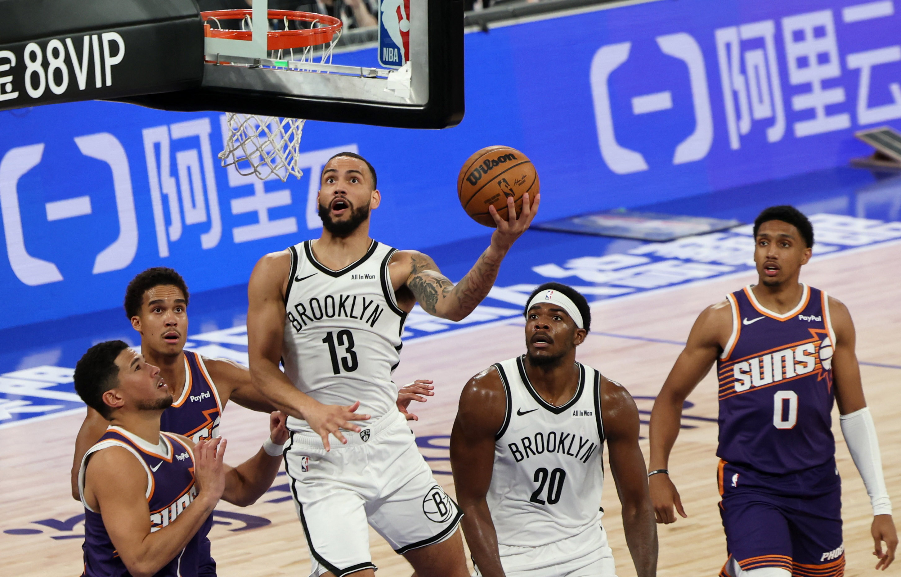 Phoenix Suns' Devin Booker in action with Brooklyn Nets' Tyrese Martin.