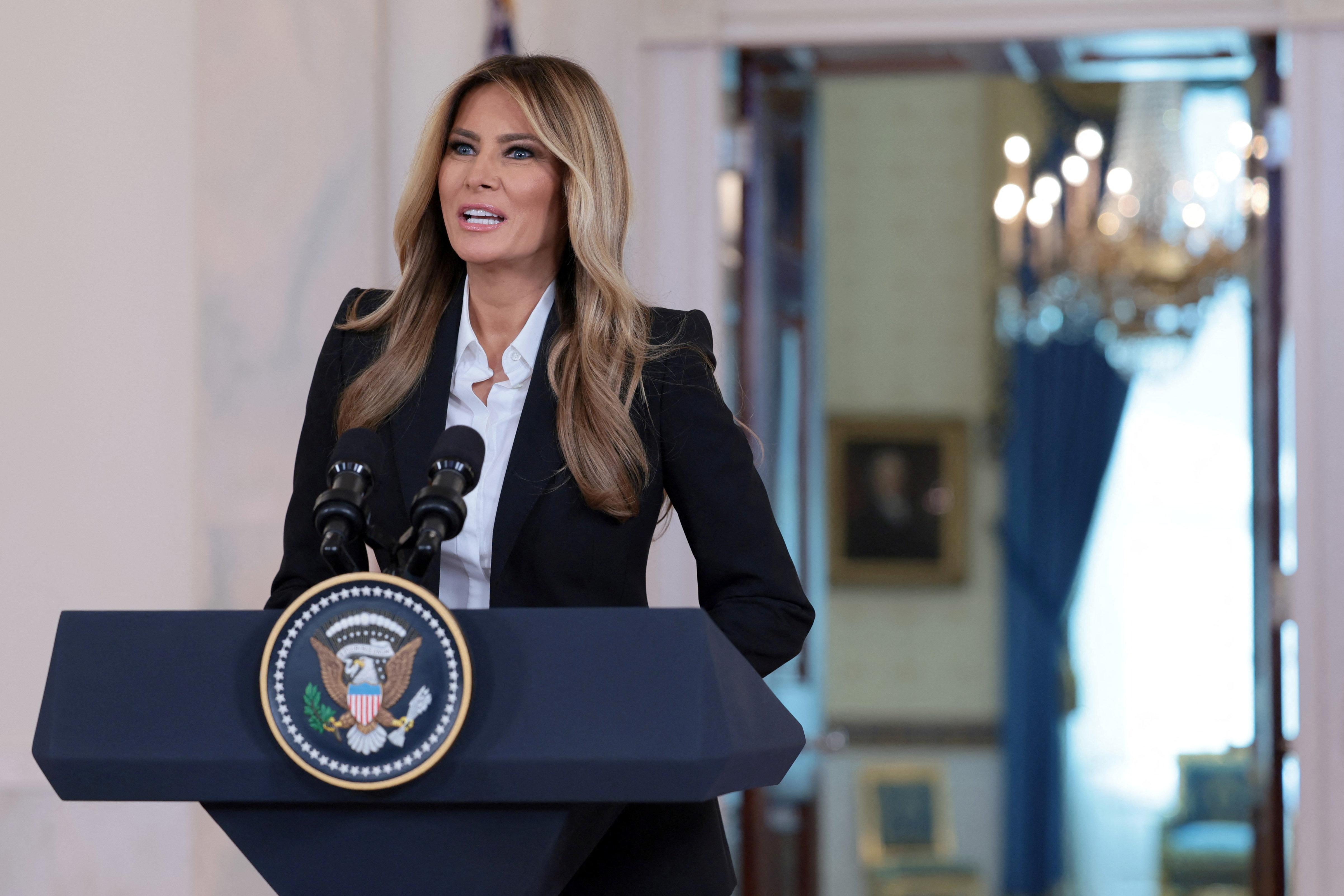 Melania Trump speaks at a podium in the White House.