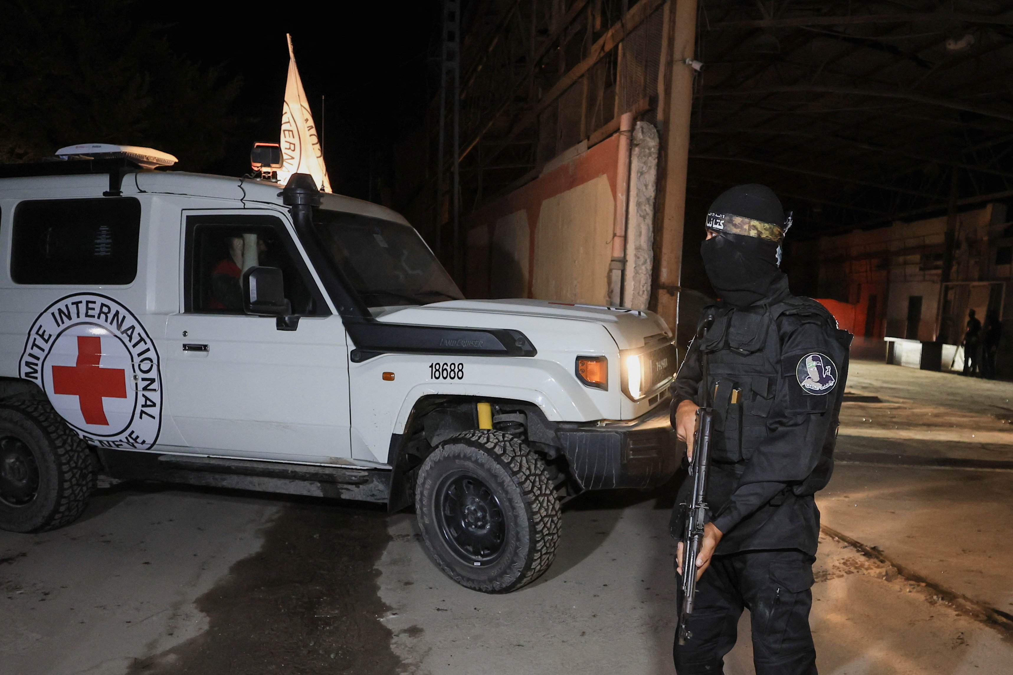 Red Cross vehicles arrive to receive from Hamas militants the bodies of deceased hostages who had been held in Gaza since the deadly October 7, 2023 attack, as part of a ceasefire and a hostages-prisoners swap deal between Hamas and Israel, in Gaza City, October 14, 2025. REUTERS/Dawoud Abu Alkas