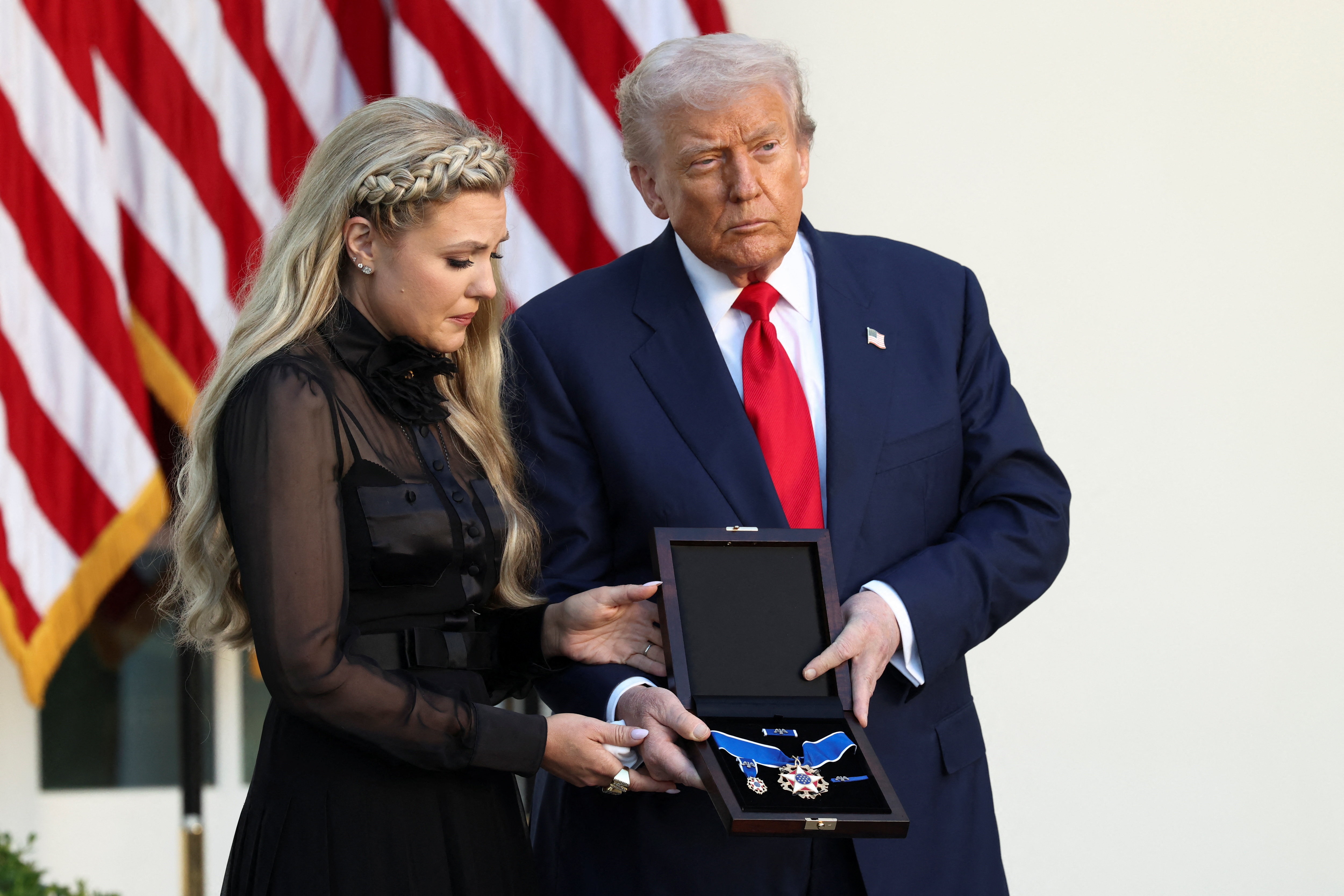 Erika Kirk, wife of slain conservative commentator Charlie Kirk, receives the Medal of Freedom posthumously awarded to Charlie Kirk by US President Donald Trump