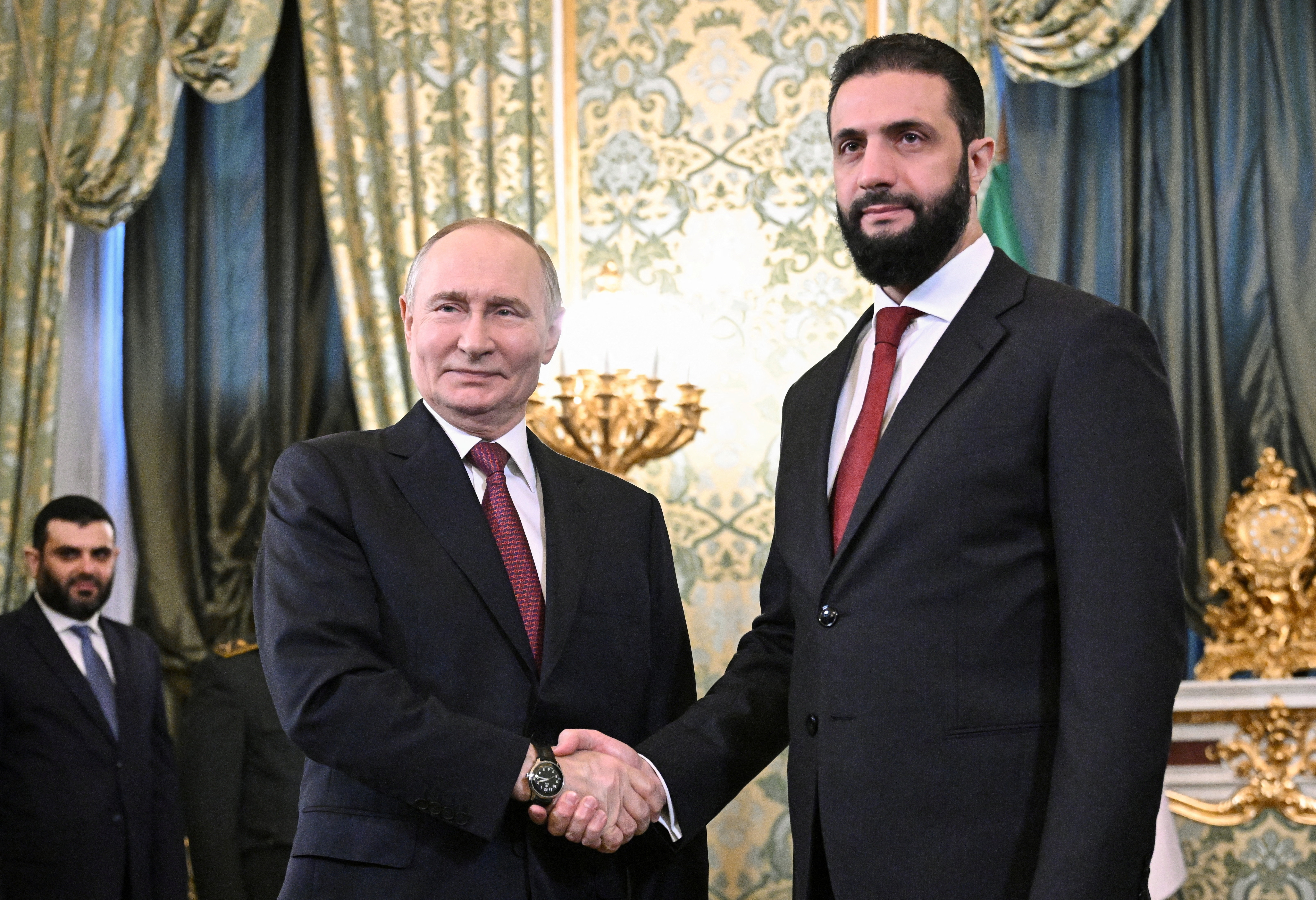 Russia's President Vladimir Putin shakes hands with Syria's President Ahmed al-Sharaa during a meeting in Moscow, Russia, October 15, 2025. Sputnik/Sergey Bobylyov/Pool via REUTERS ATTENTION EDITORS - THIS IMAGE WAS PROVIDED BY A THIRD PARTY. 