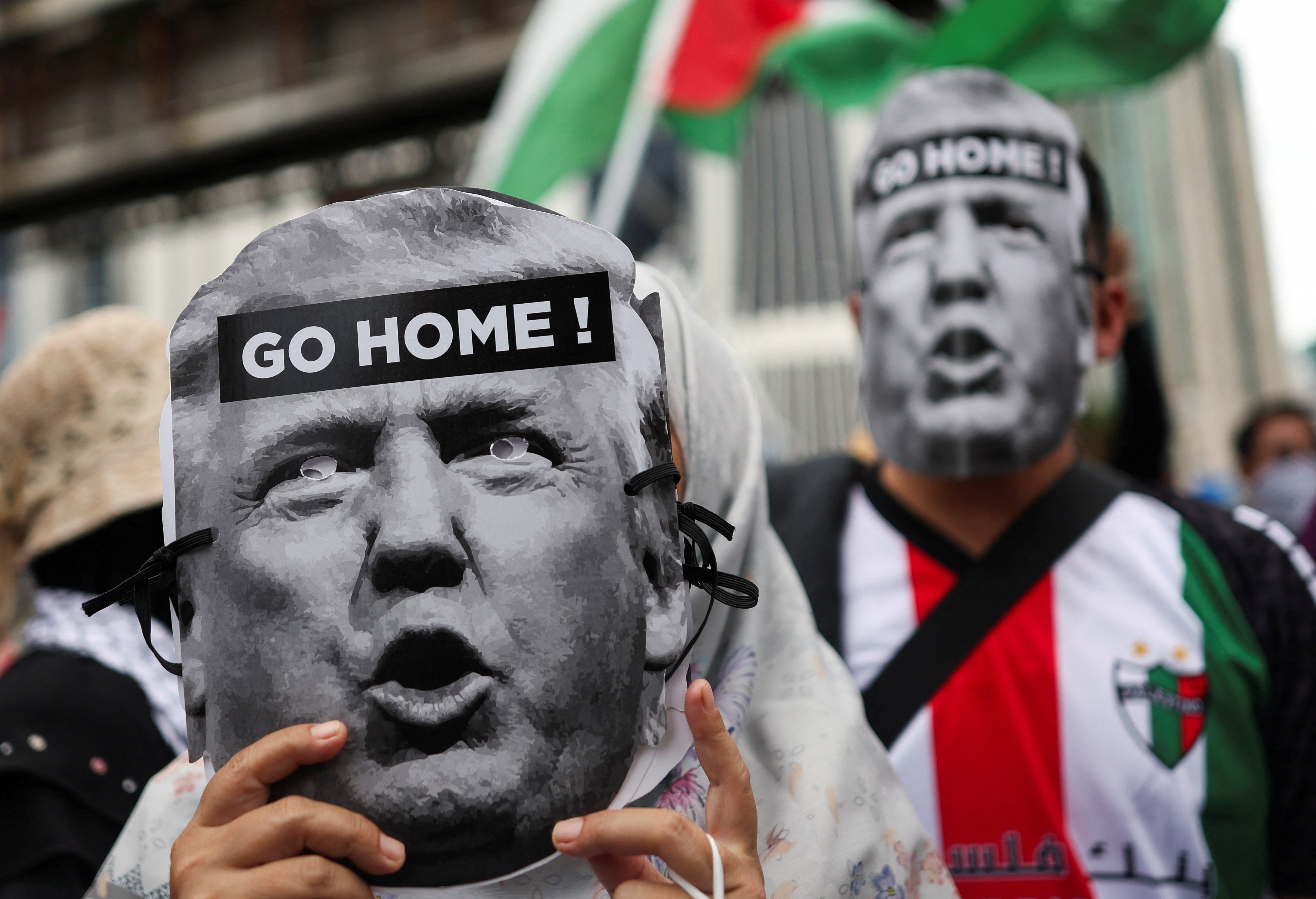 Pro-Palestinian demonstrators hold cutouts of US President Donald Trump&rsquo;s face on October 24, 2025, as they march to the US embassy to protest the president's visit to Malaysia for the ASEAN summit in Kuala Lumpur [Hasnoor Hussain/Reuters]