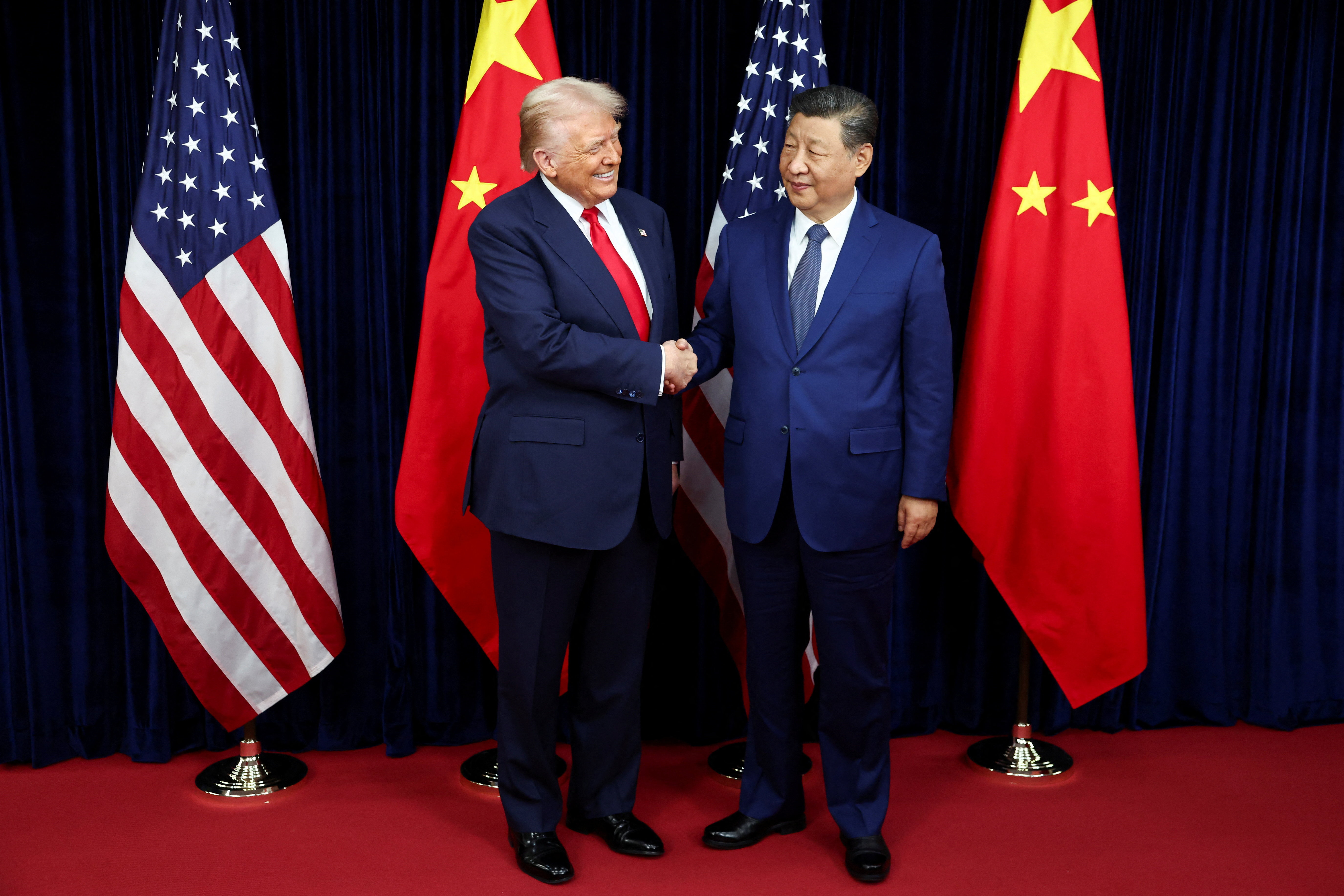 U.S. President Donald Trump shakes hands with Chinese President Xi Jinping