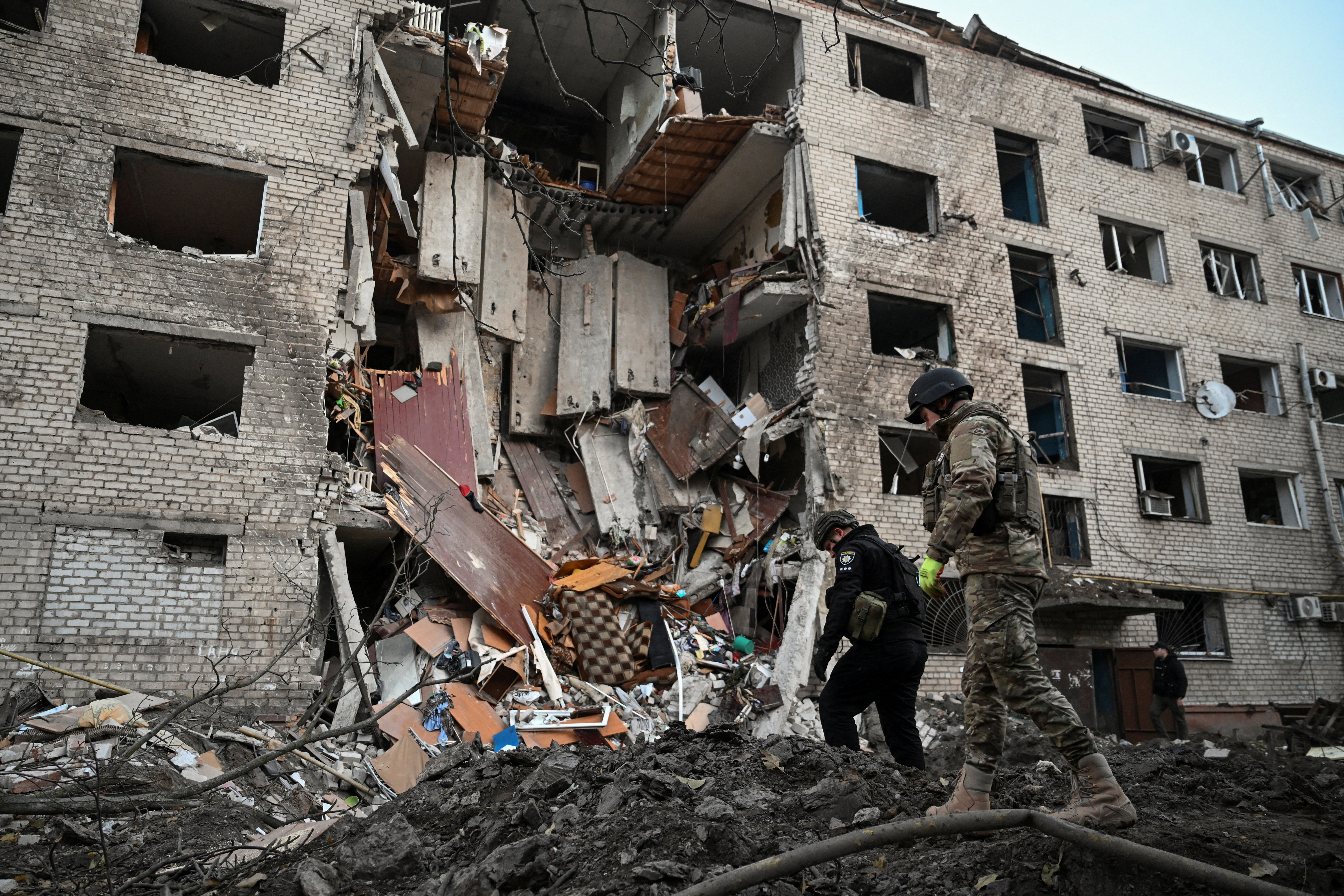 Police investigators inspect debris at a site of a dormitory building heavily damaged during an overnight Russian missile and drone strikes, amid Russia's attack on Ukraine, in Zaporizhzhia, Ukraine October 30, 2025. REUTERS/Stringer TPX IMAGES OF THE DAY