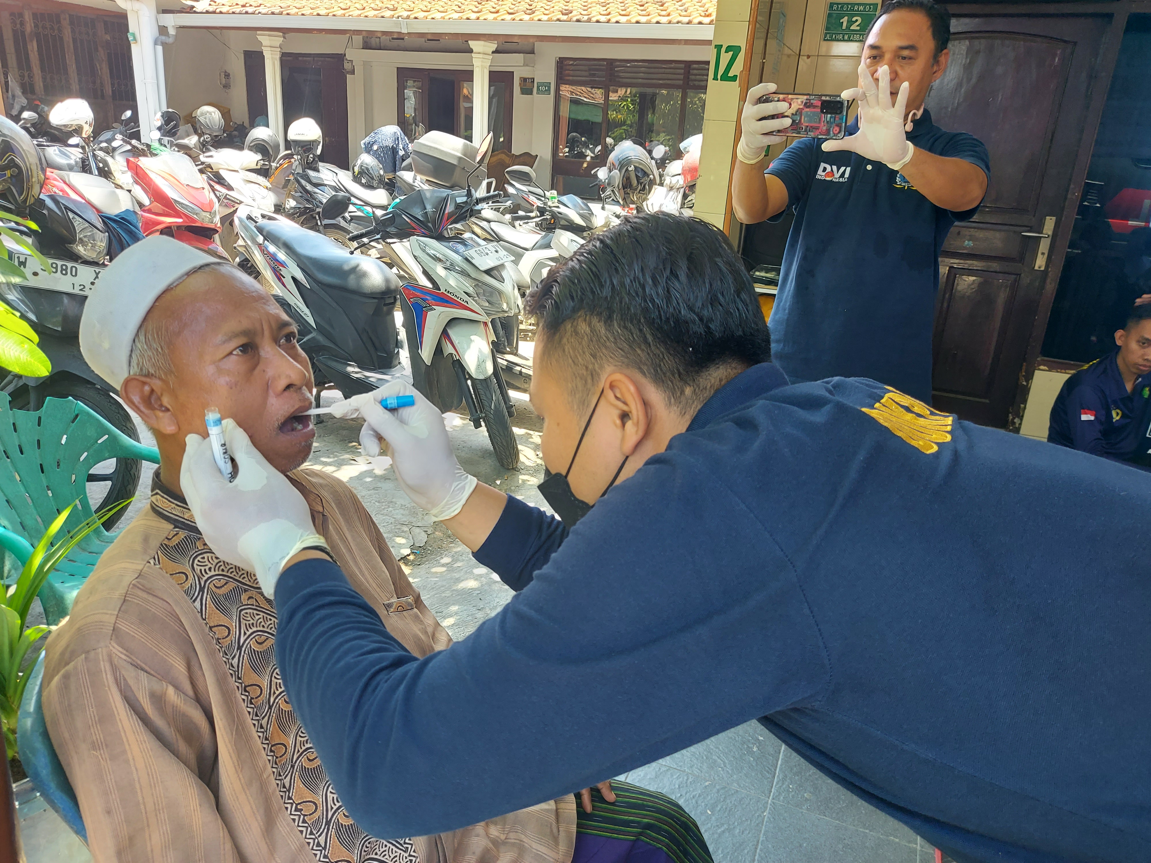 Ahmad Ichsan, whose son is missing, provides a DNA sample at the site of the school collapse in Sidoarjo, East Java, Indonesia, on October 2, 2025 [Aisyah llewellyn/AL Jazeera]