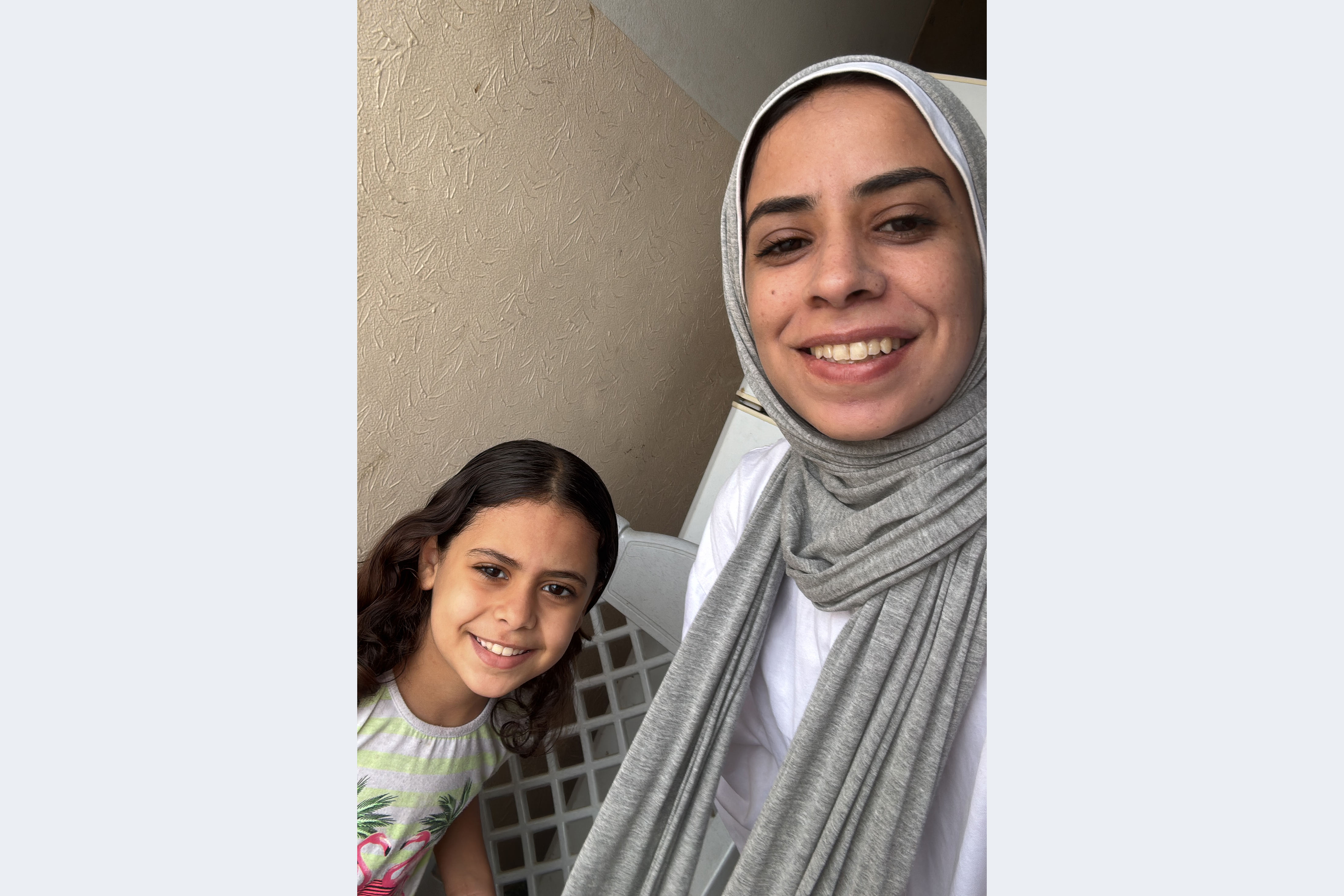 Maram Humaid, right, with her daughter Banias, left, at home in Deir al-Balah, Gaza, just after the ceasefire was announced