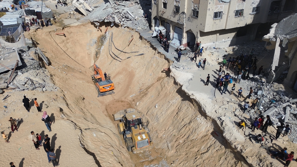 An aerial view shows heavy machineries during the search and recovery operations continue to recover the bodies of Israeli hostages from the rubble of buildings destroyed by Israeli attacks, at Hamad Site in Khan Yunis, Gaza on October 21, 2025. Photojournalist:Muhammed Eslayeh