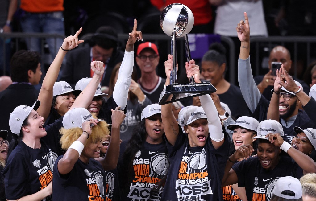 PHOENIX, ARIZONA - OCTOBER 10: A'ja Wilson #22 of the Las Vegas Aces holds up the championship trophy after winning game four of the 2025 WNBA Playoffs finals at Mortgage Matchup Center on October 10, 2025 in Phoenix, Arizona. The Las Vegas Aces defeat the Phoenix Mercury 97-86 to win the championship. NOTE TO USER: User expressly acknowledges and agrees that, by downloading and or using this photograph, User is consenting to the terms and conditions of the Getty Images License Agreement. Chris Coduto/Getty Images/AFP (Photo by Chris Coduto / GETTY IMAGES NORTH AMERICA / Getty Images via AFP)