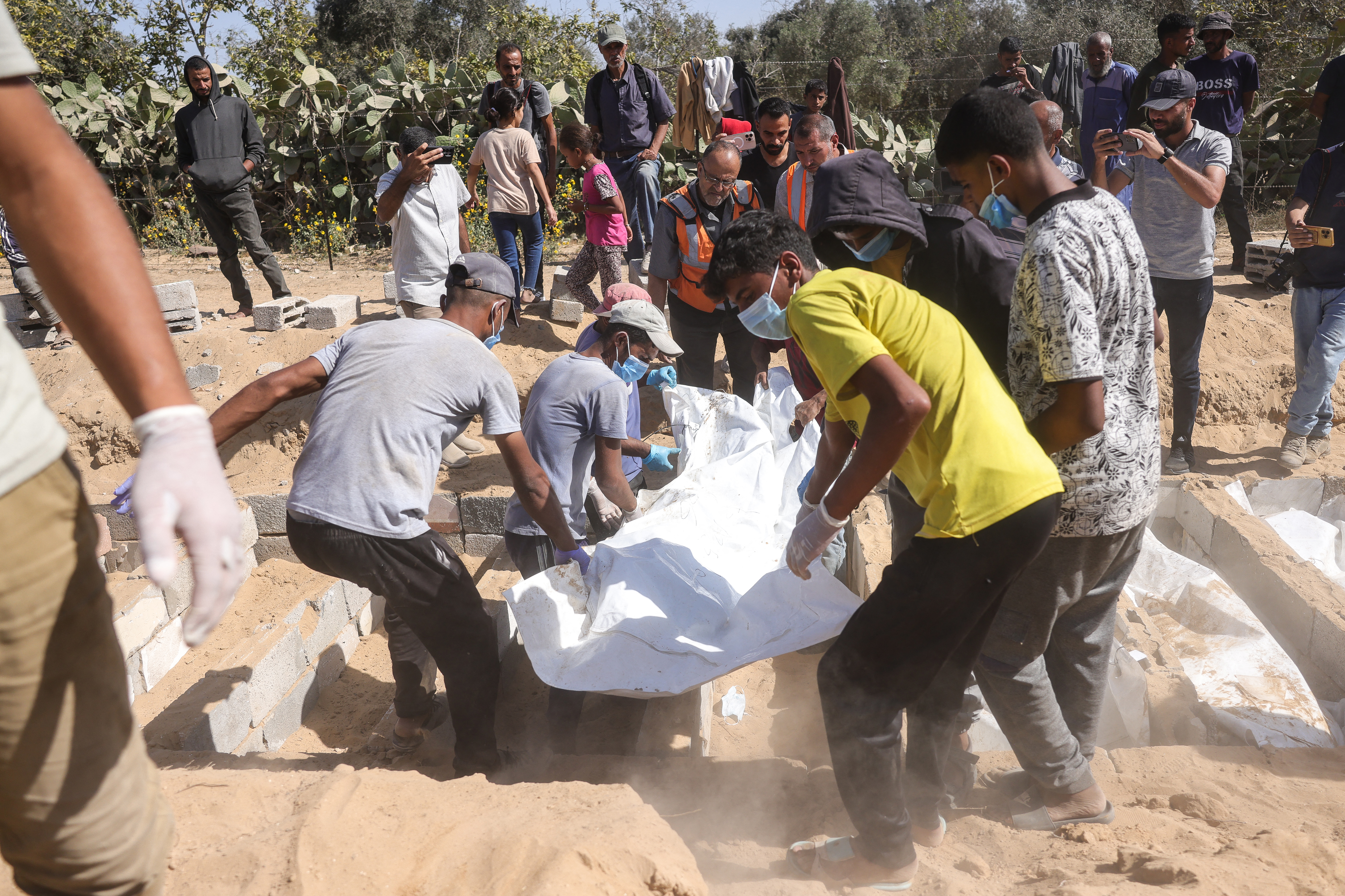 Families mourn as mass burial held for unidentified Palestinians in Gaza