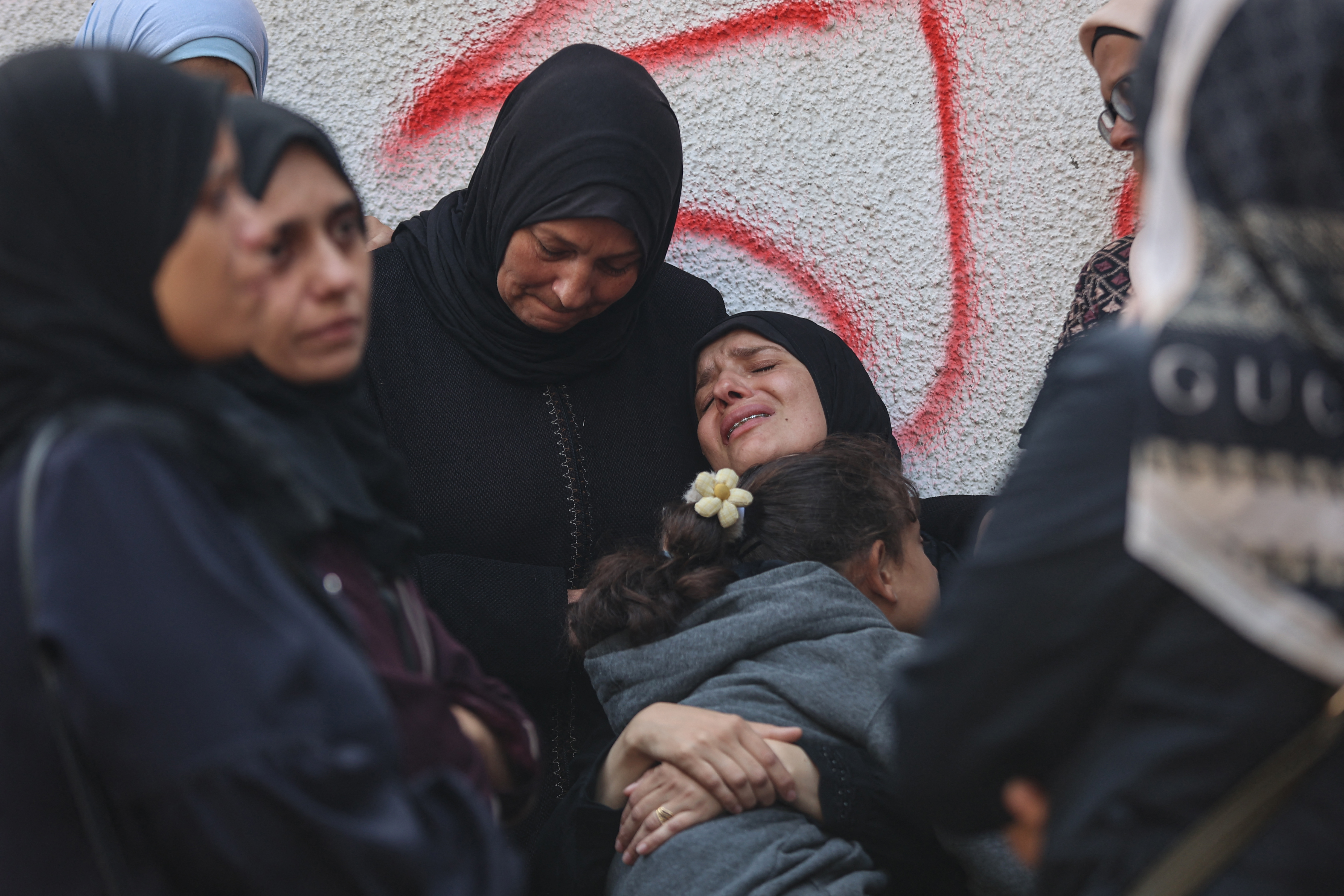 Palestinians mourn the death of loved ones killed in overnight Israeli strikes at the Al-Shifa Hospital in Gaza City