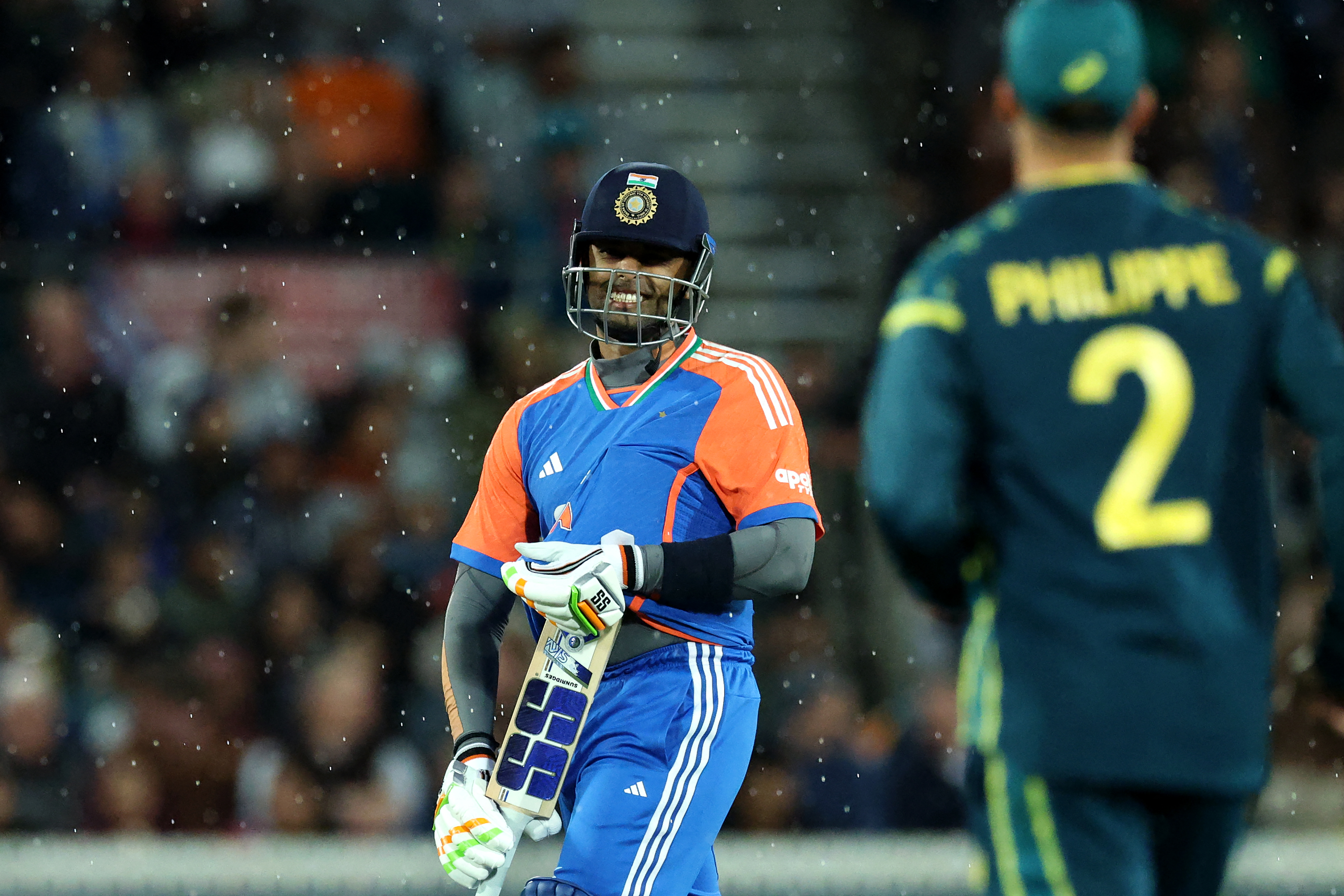 India's Suryakumar Yadav walks off the field as rain interrupts play during the first Twenty20 international cricket match between Australia and India