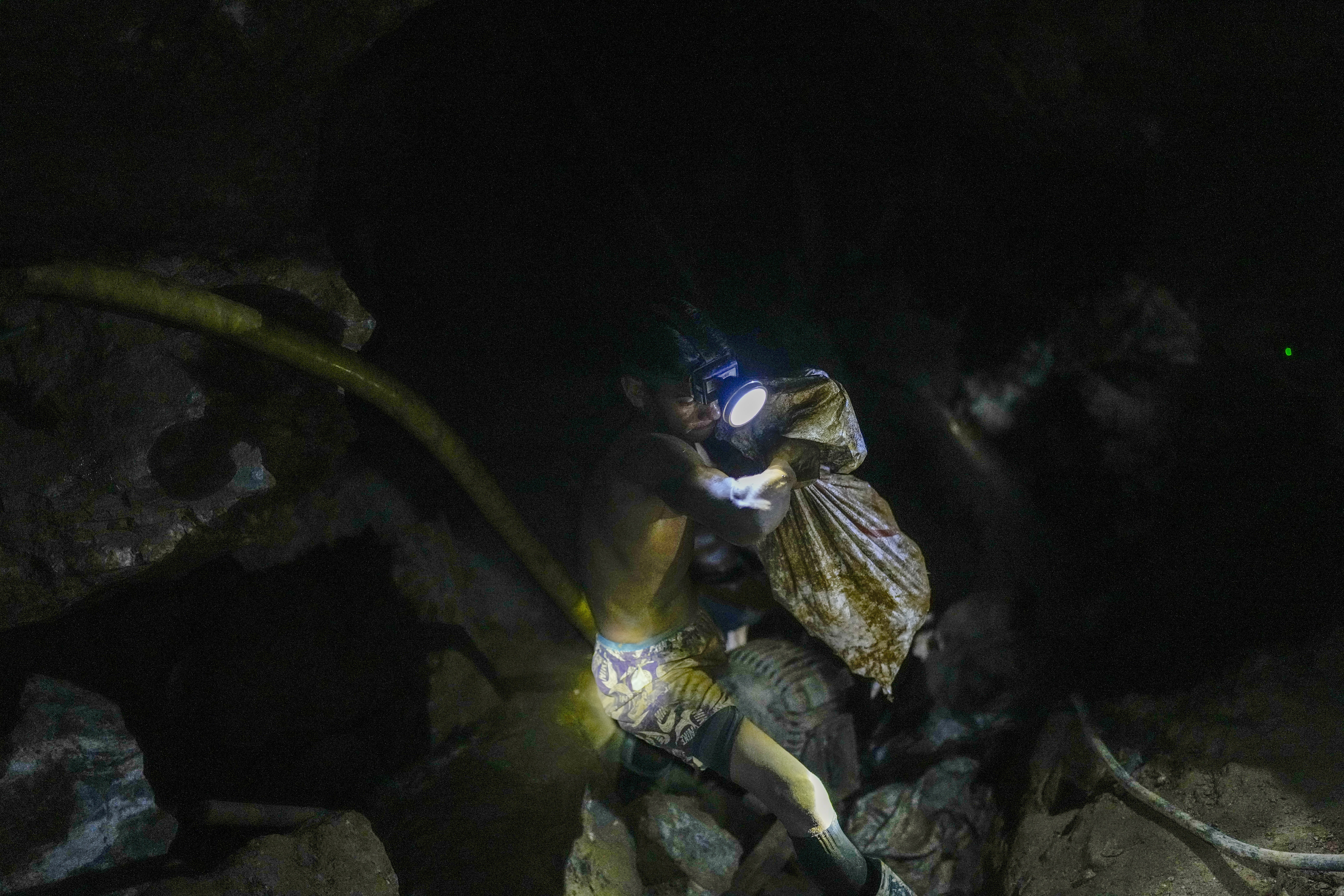 A gold miner heads to the surface in an underground mine in El Callao, Venezuela