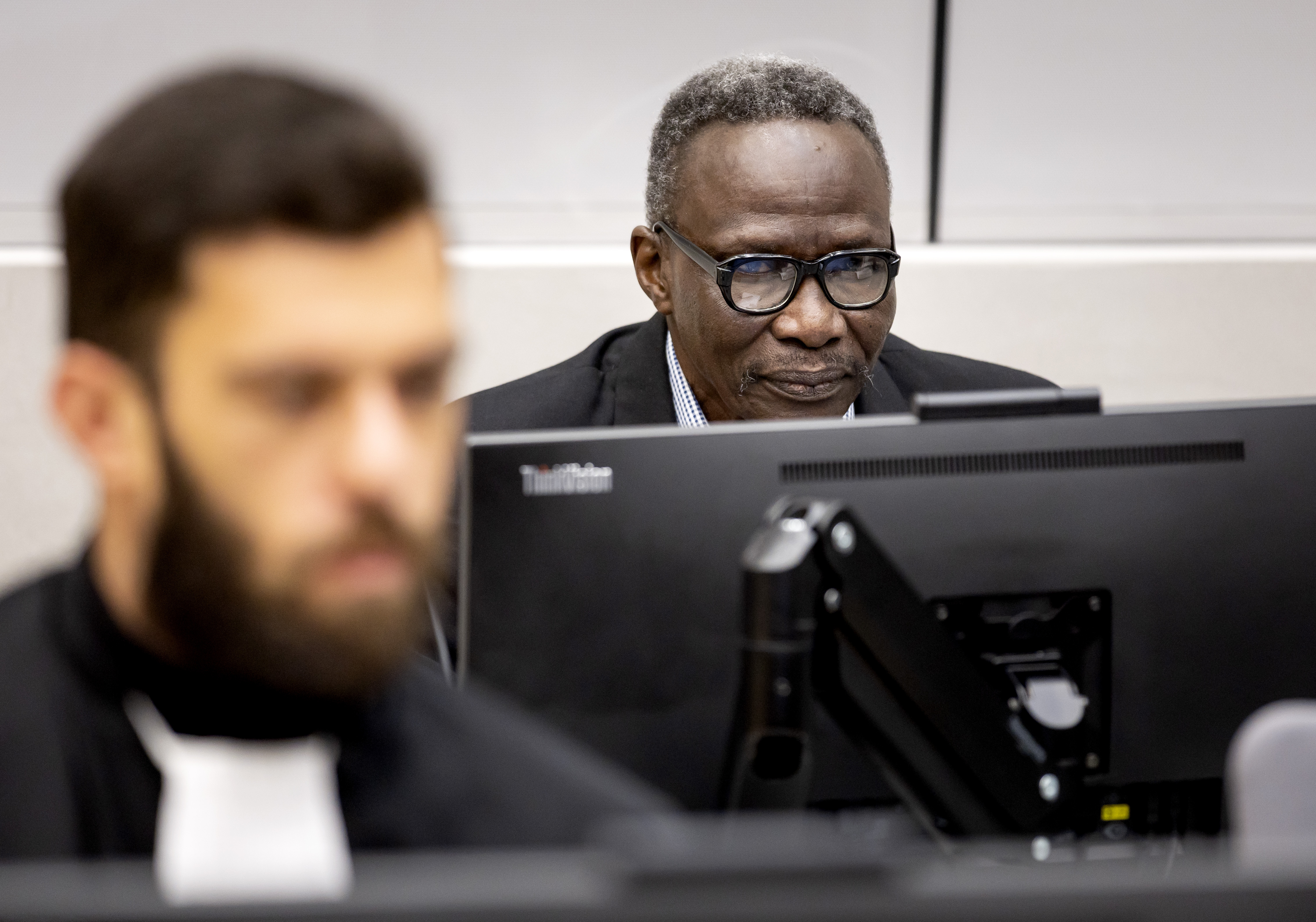 Ali Muhammad Ali Abd al-Rahman, rear right, a Sudanese national, during a hearing at the International Criminal Court in The Hague, The Netherlands, Thursday, Oct. 19, 2023