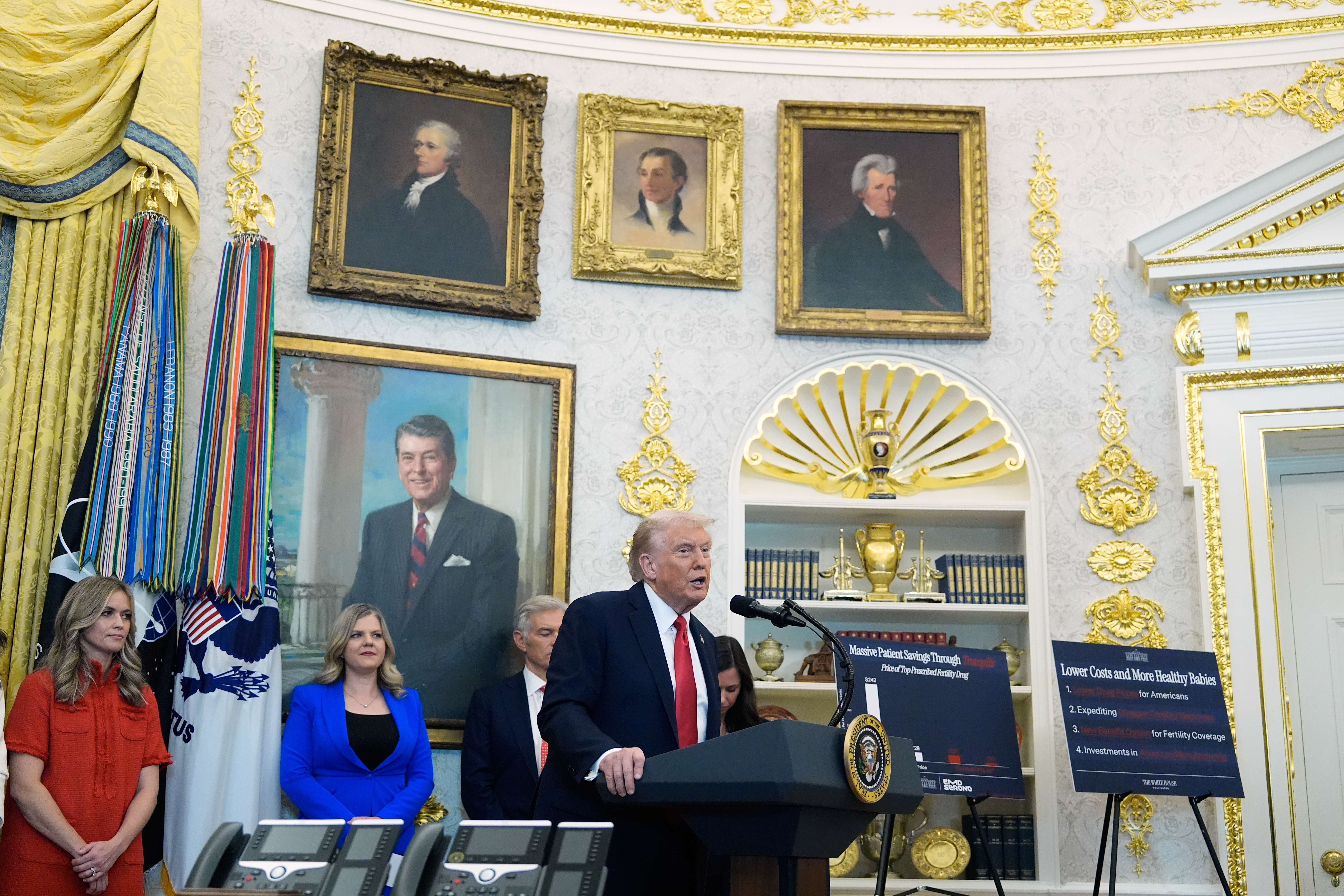 Donald Trump stands at a podium in the Oval Office.