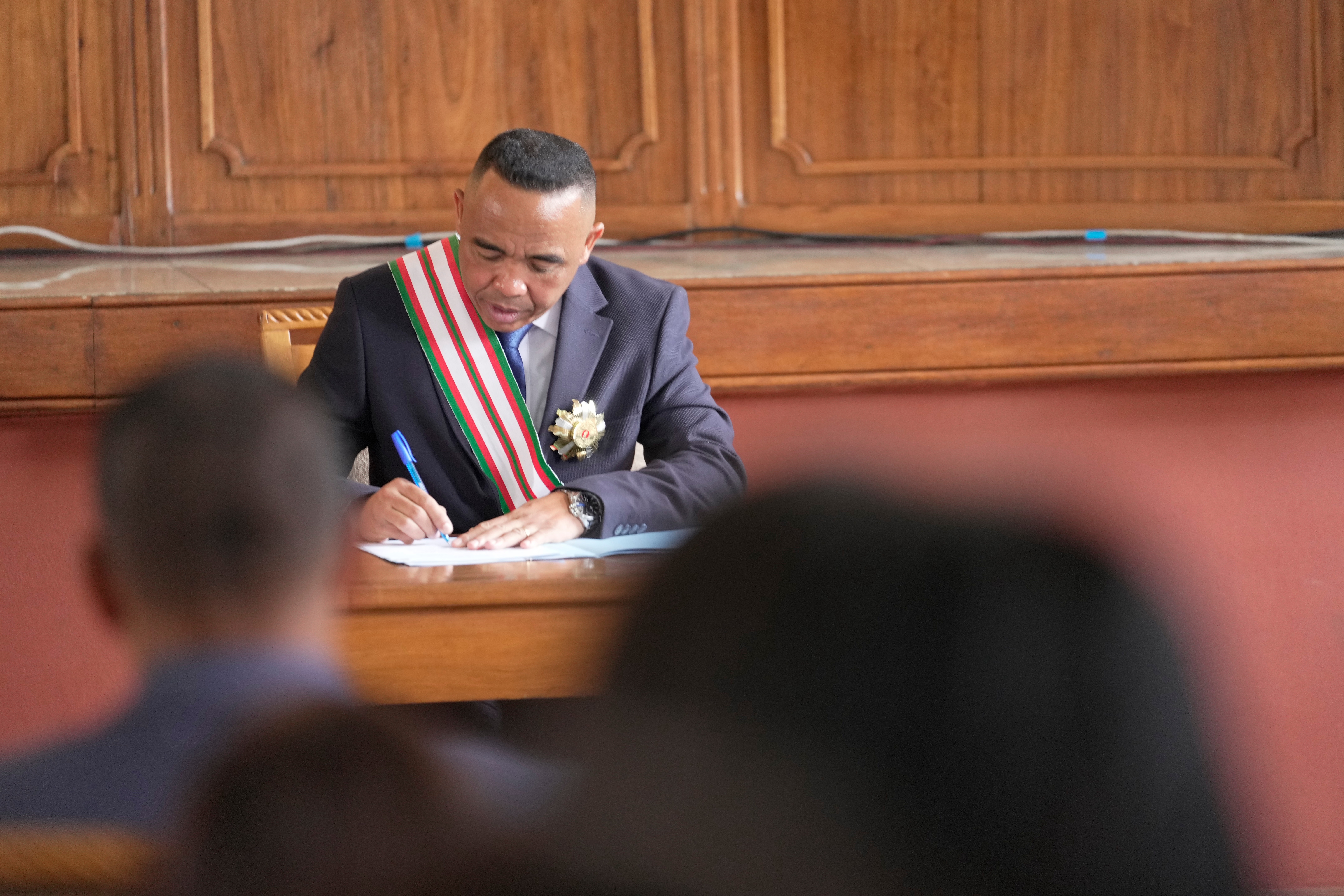 Colonel Michael Randrianirina signs documents at the high constitutional court after being sworn in as president in Antananarivo, Madagascar in October 2025