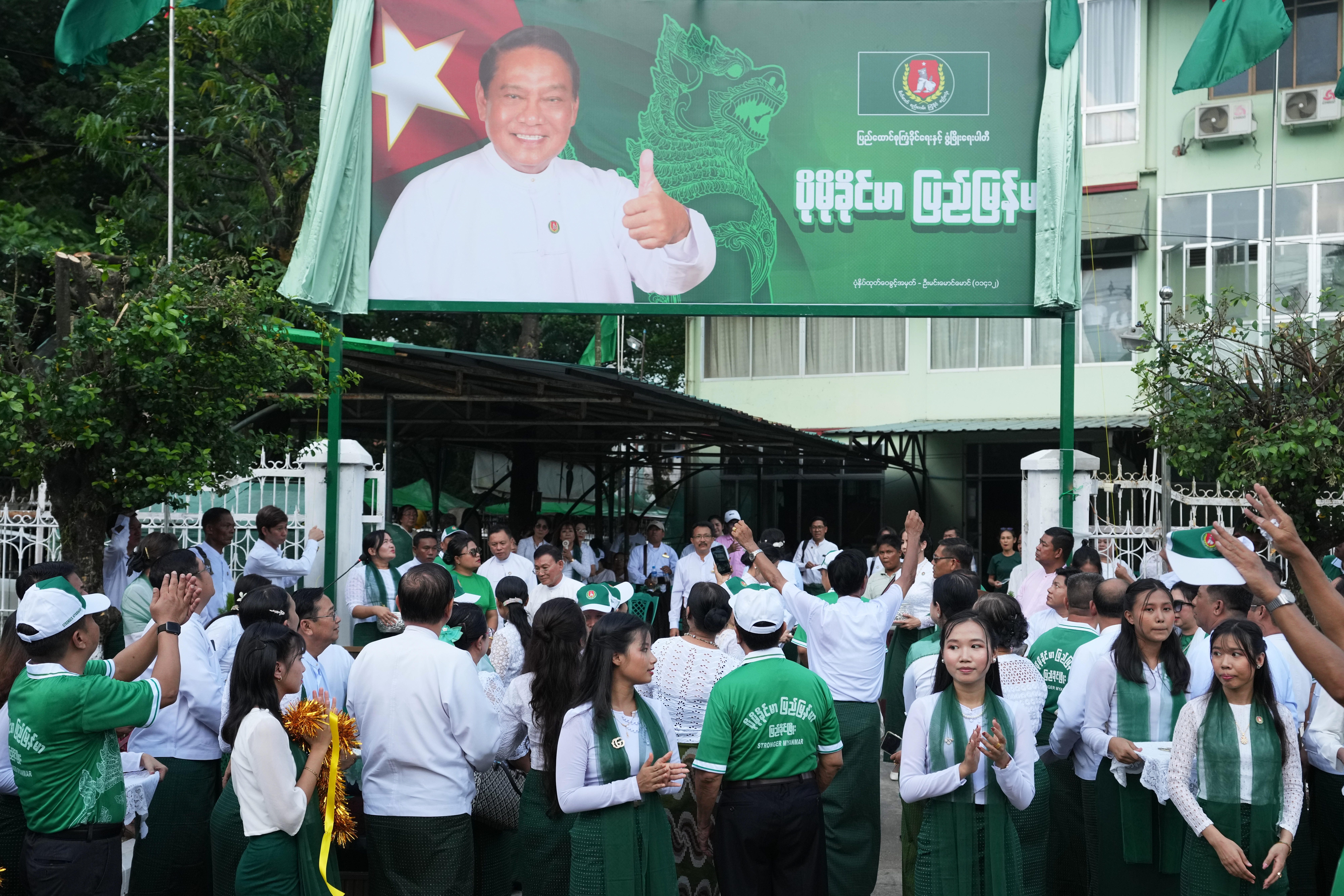 Members of the military-backed Union Solidarity and Development Party (USDP) gather for opening ceremony of the party's slogan poster during the first day of election campaign for upcoming general election at their Yangon region party's headquarters Tuesday, Oct. 28, 2025, in Yangon, Myanmar. (AP Photo/Thein Zaw)