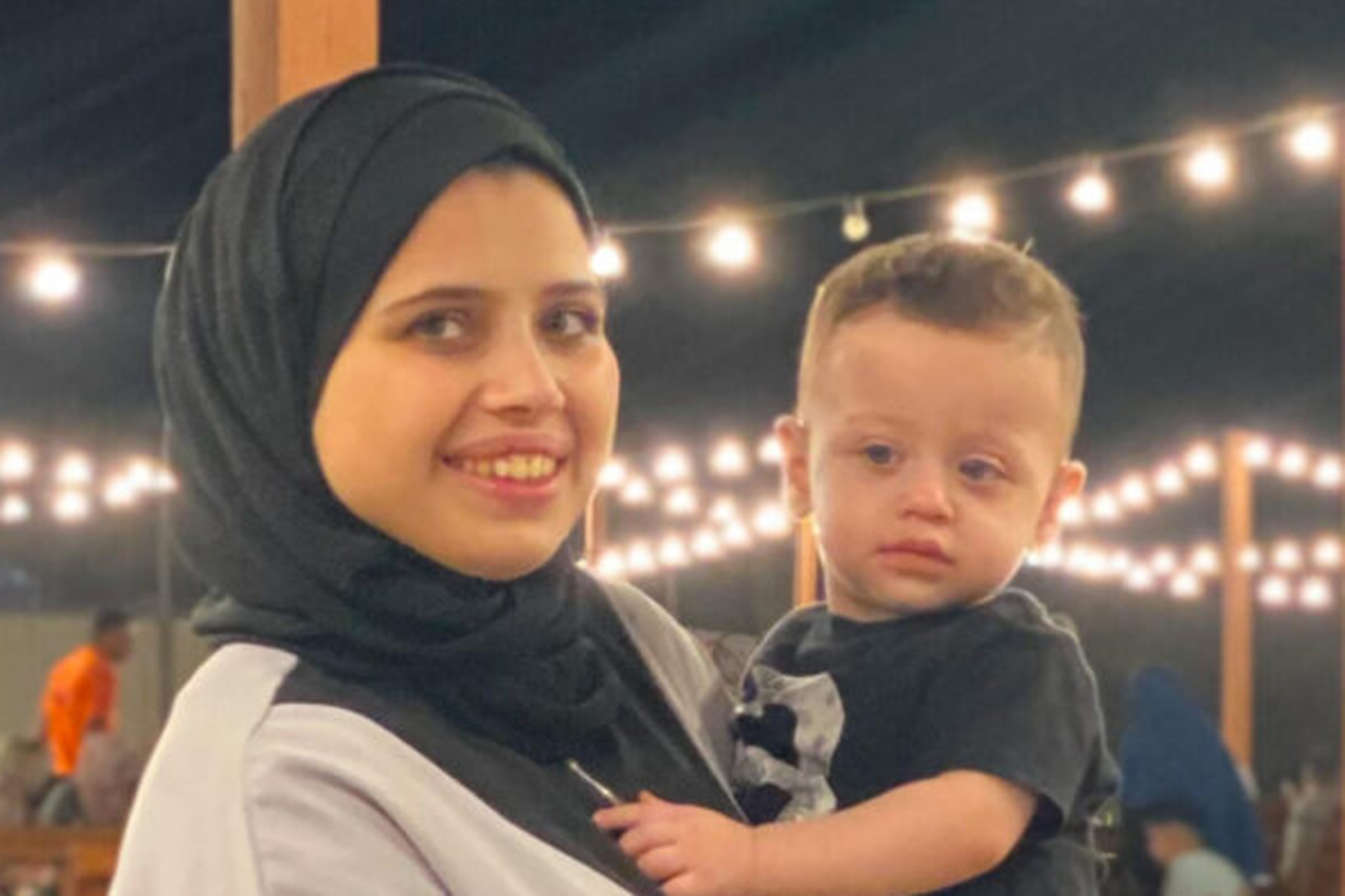 A photo of a young woman holding a toddler