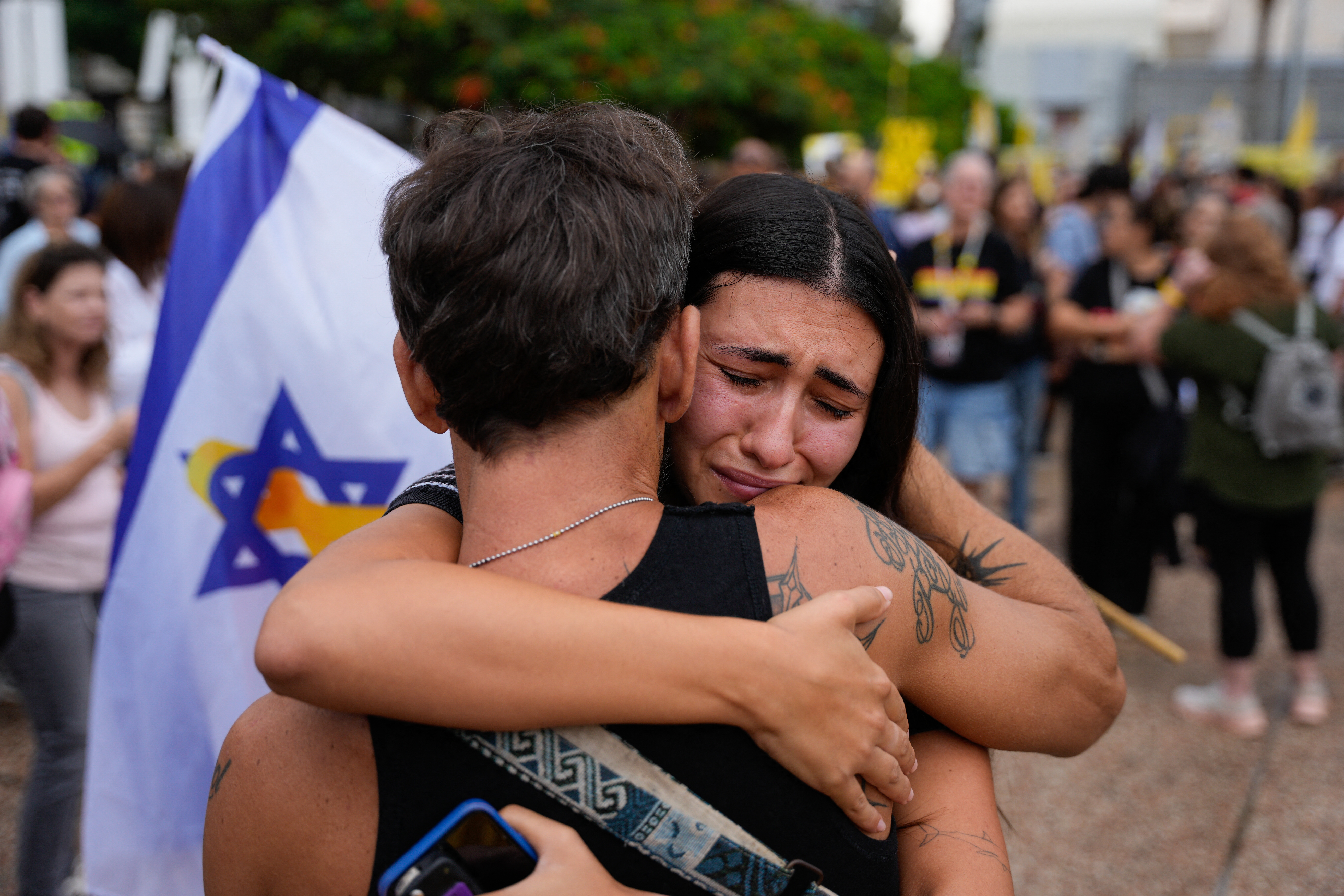 People hug each other and cry.