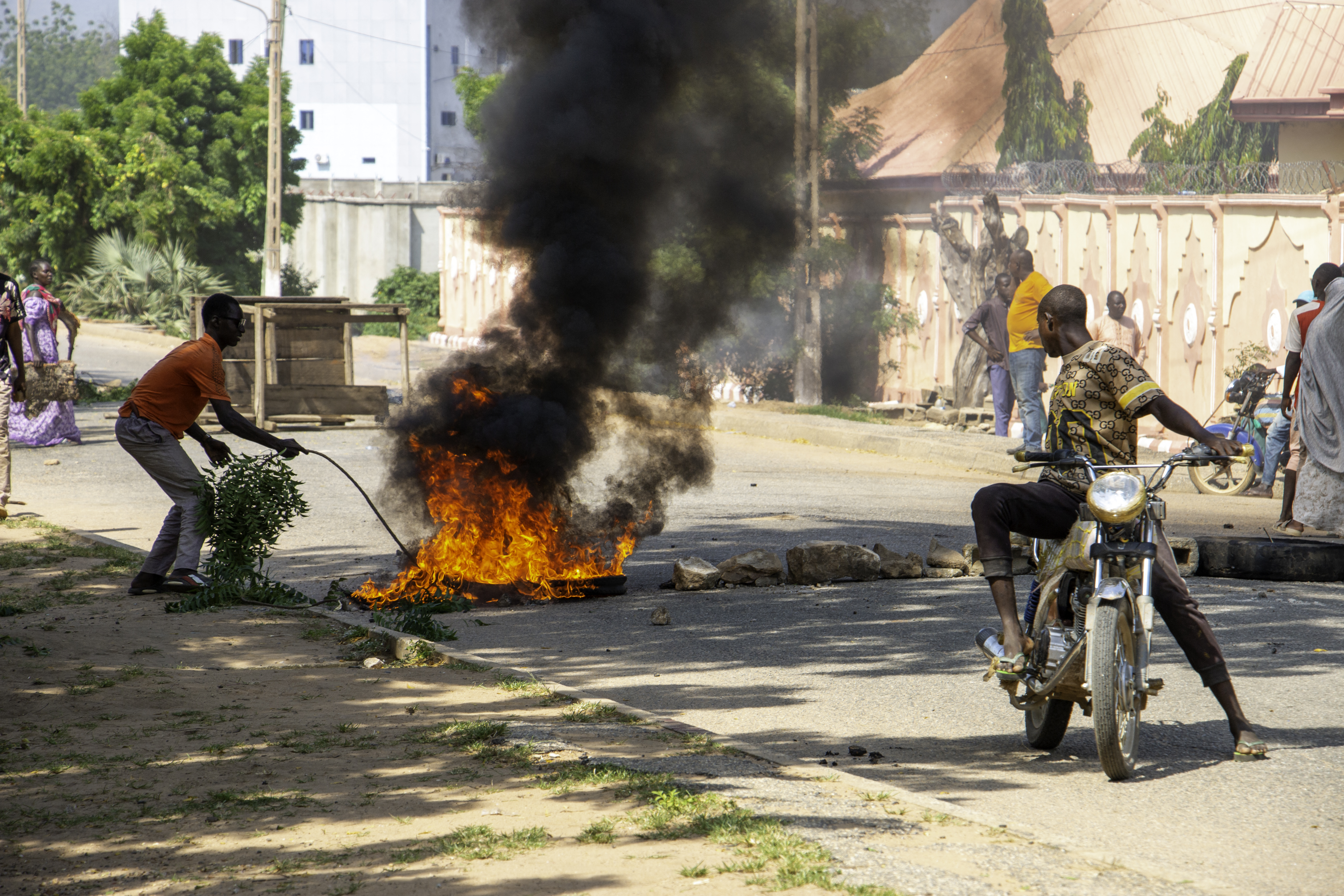 Burning barricades are seen in Garoua during a demonstration by supporters of the political opposition on October 21, 2025 ahead of the release of the results of the presidential vote. (Photo by AFP)