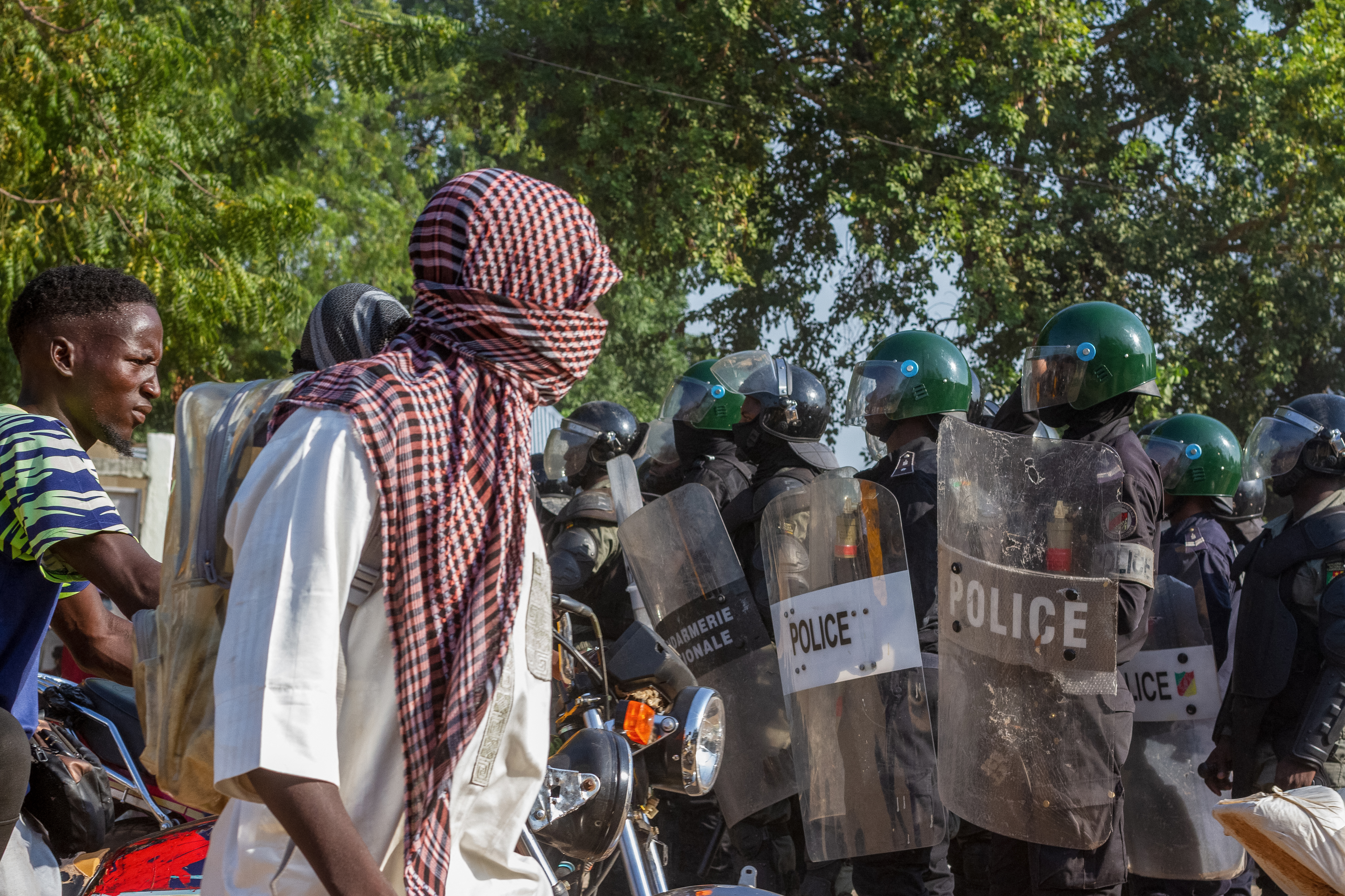 Protesters approach Cameroonian police officers as they gather in Garoua on October 26, 2025.