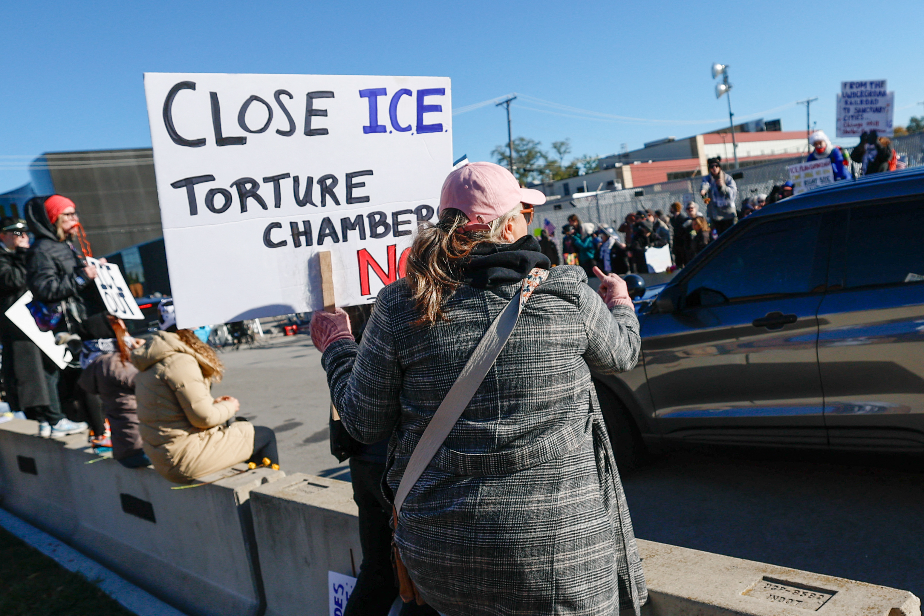 Demonstrators protest against Immigration and Customs Enforcement (ICE) outside an ICE facility in Broadview, Illinois on October 24, 2025.